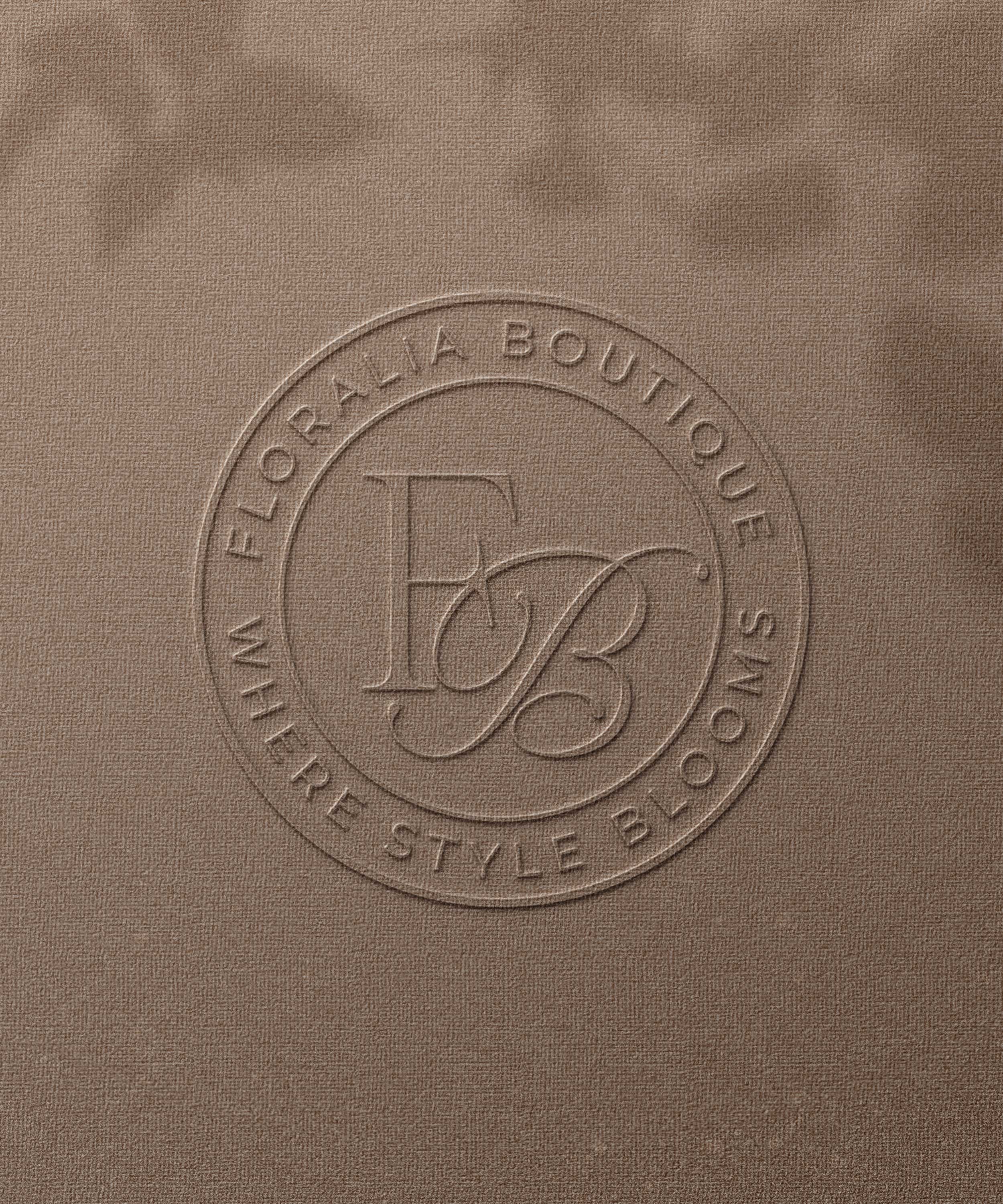 Embossed logo with the initials 'EB' on a brown textured surface.