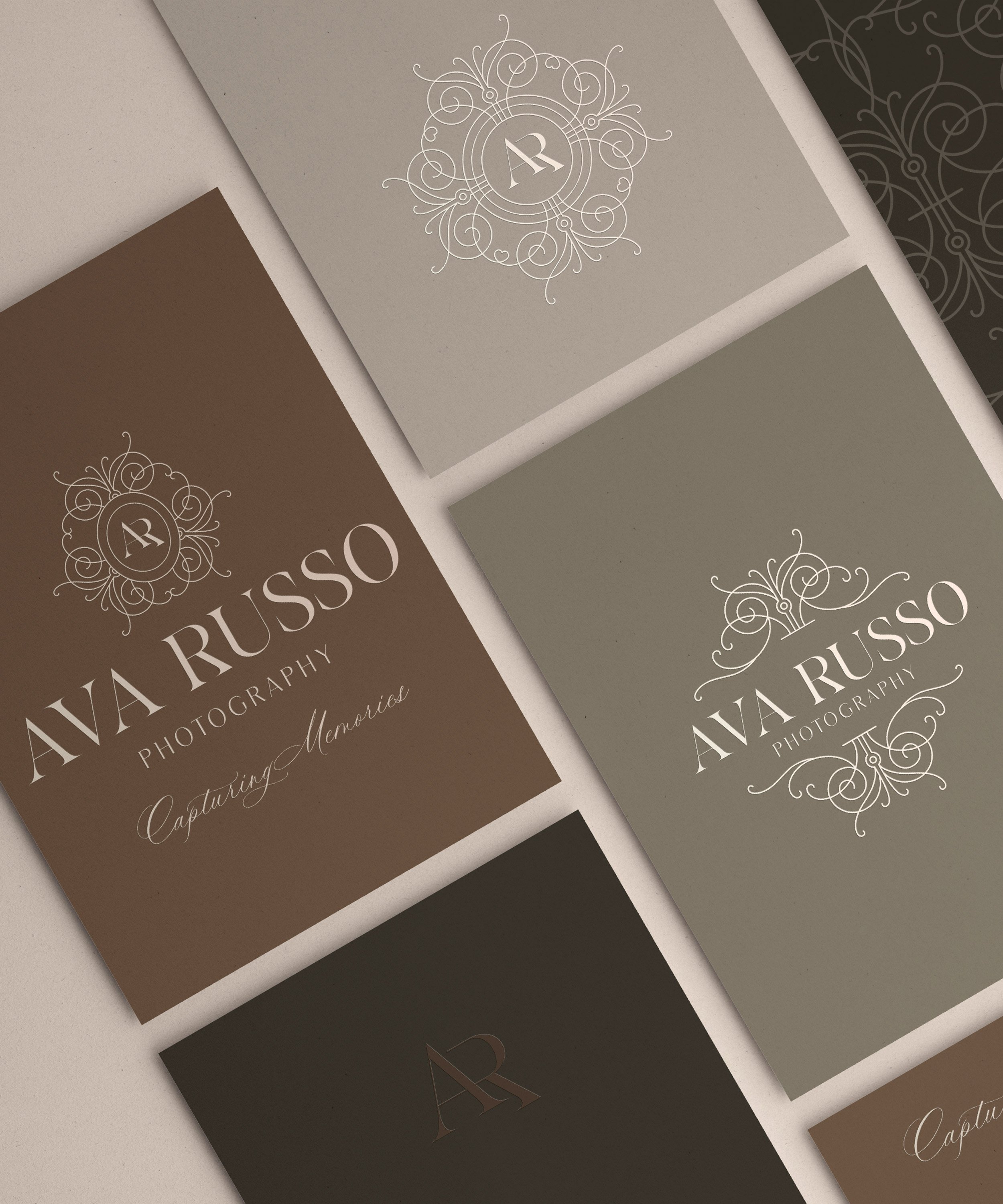 Business cards for Ava Russo Photography in various neutral tones with elegant white script and swirl designs, featuring the name and logo.
