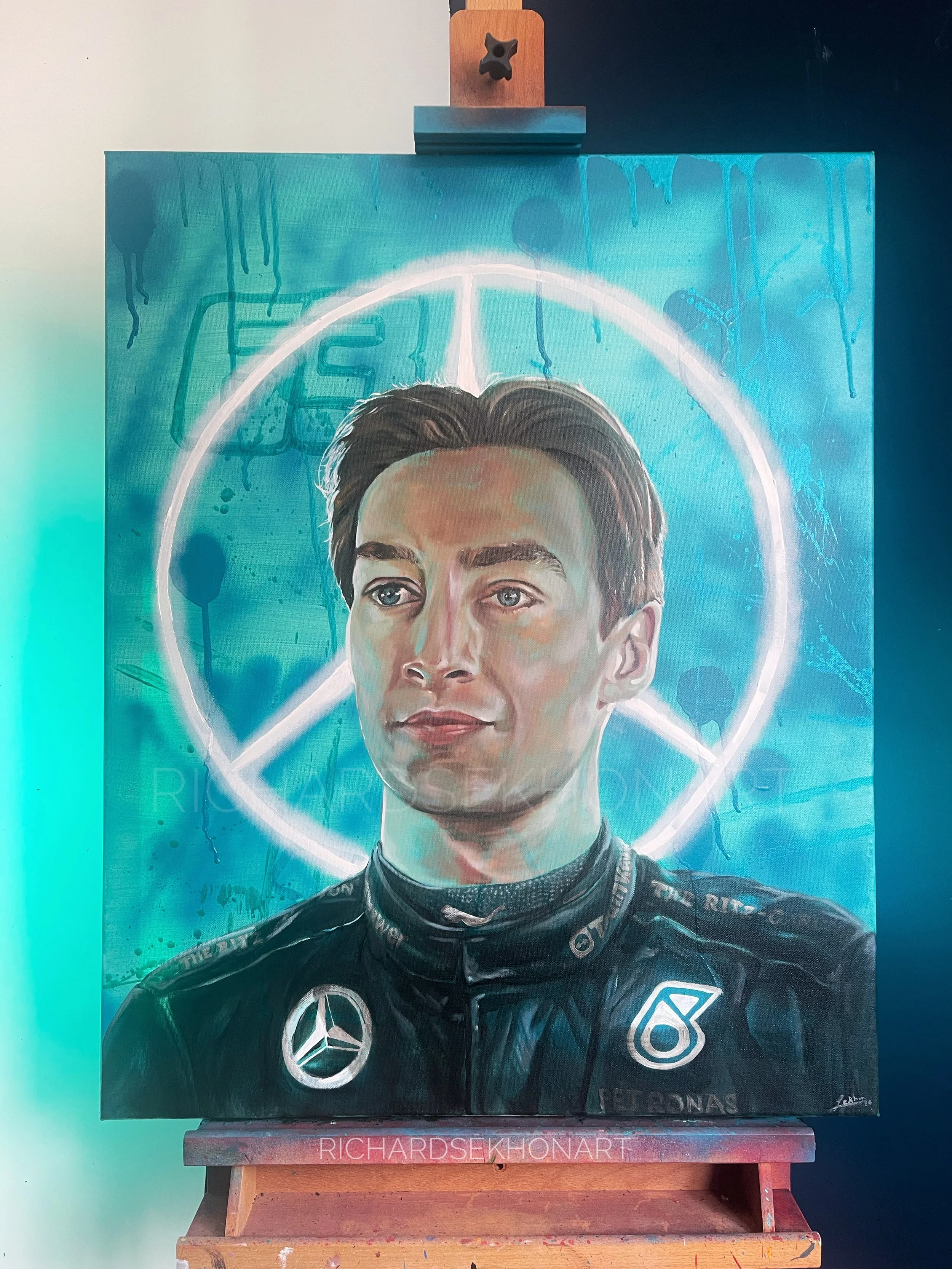 portrait of a racing driver with team logo behind him