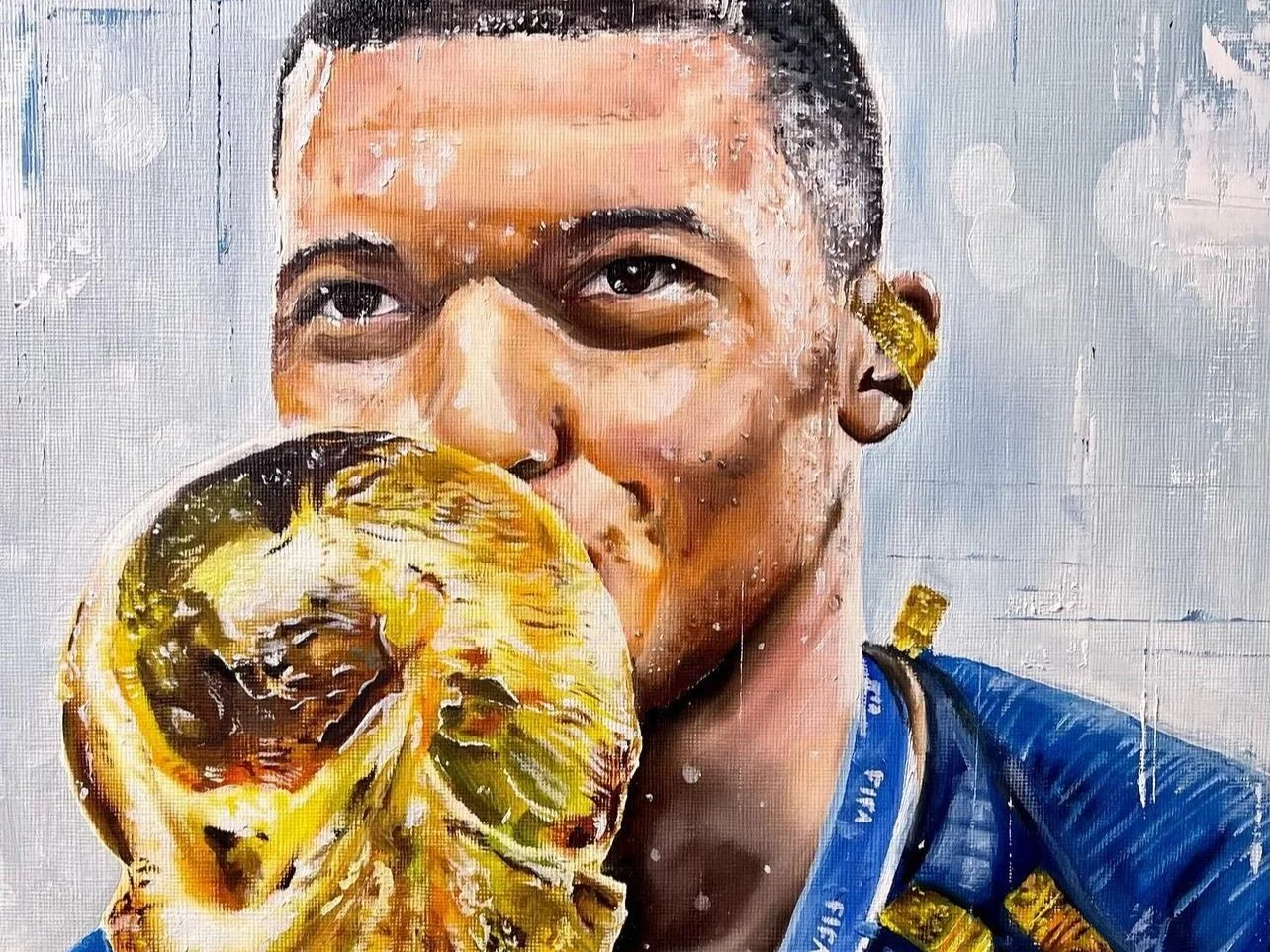 footballer kissing a trophy