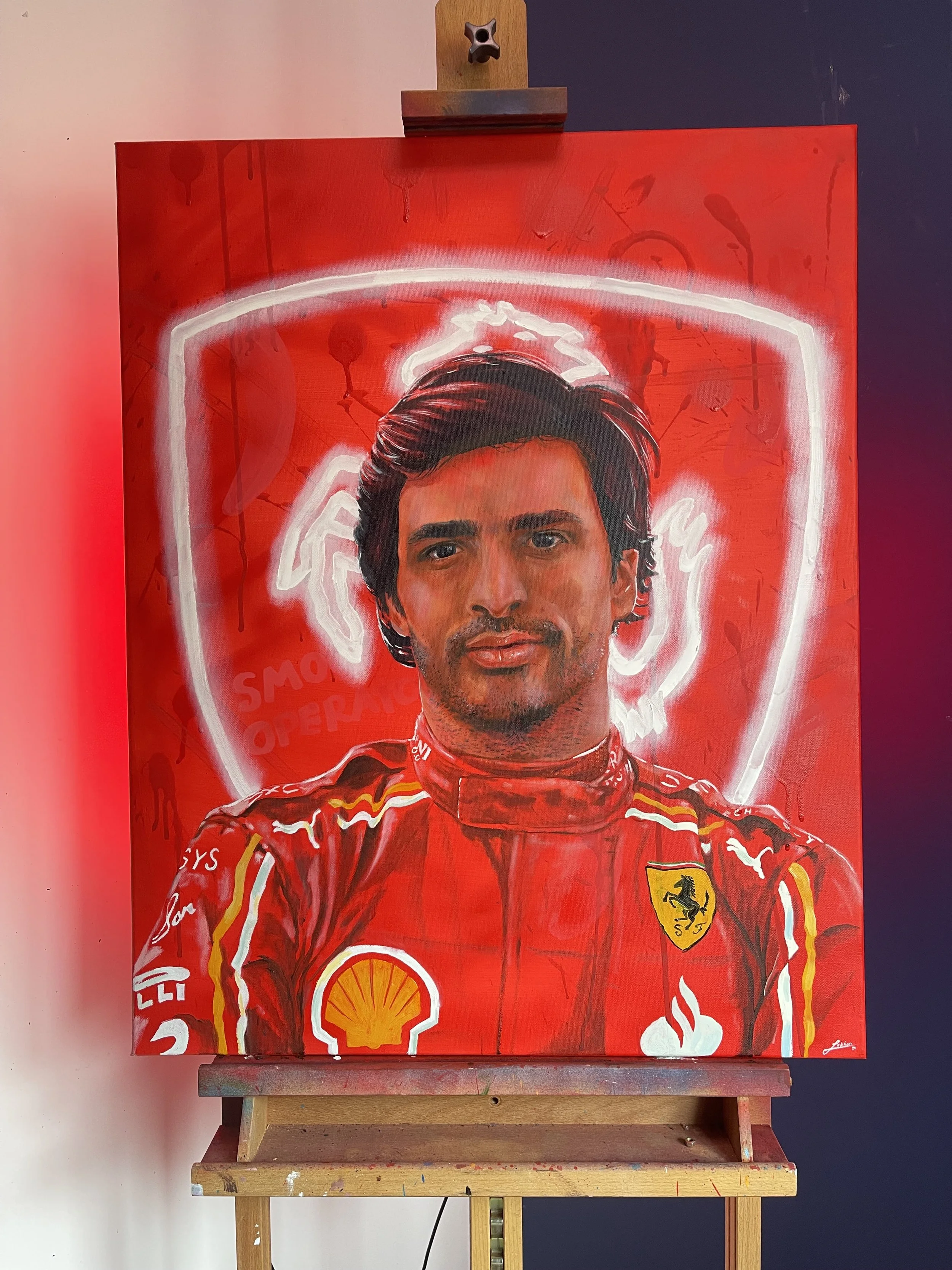 portrait of a racing driver with team logo behind him