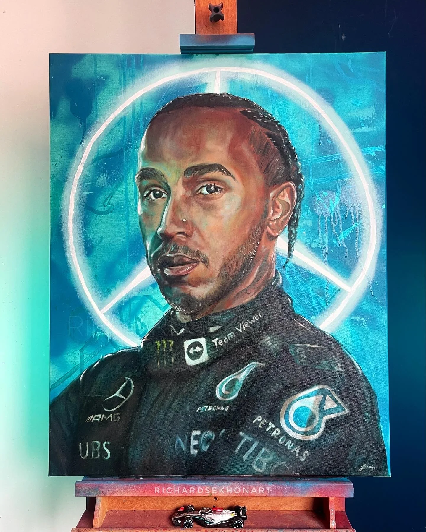 portrait of a racing driver with team logo behind him