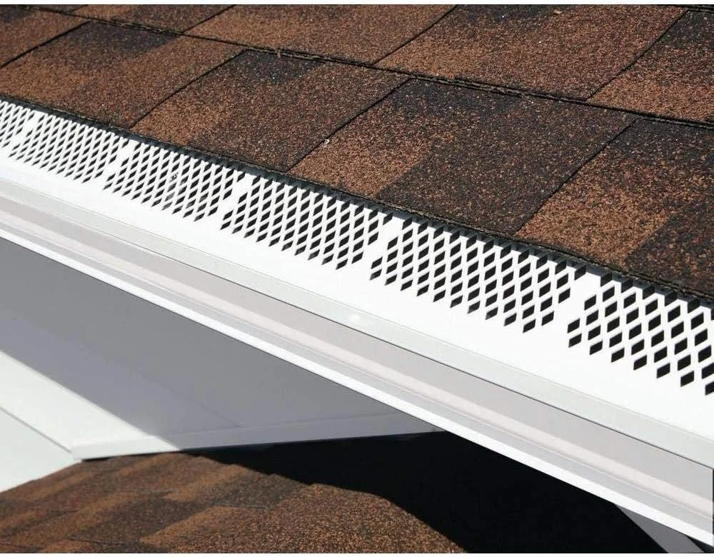 White diamond-pattern mesh screen representing affordable types of gutter guards designed to catch leaves and prevent clogged downspouts.