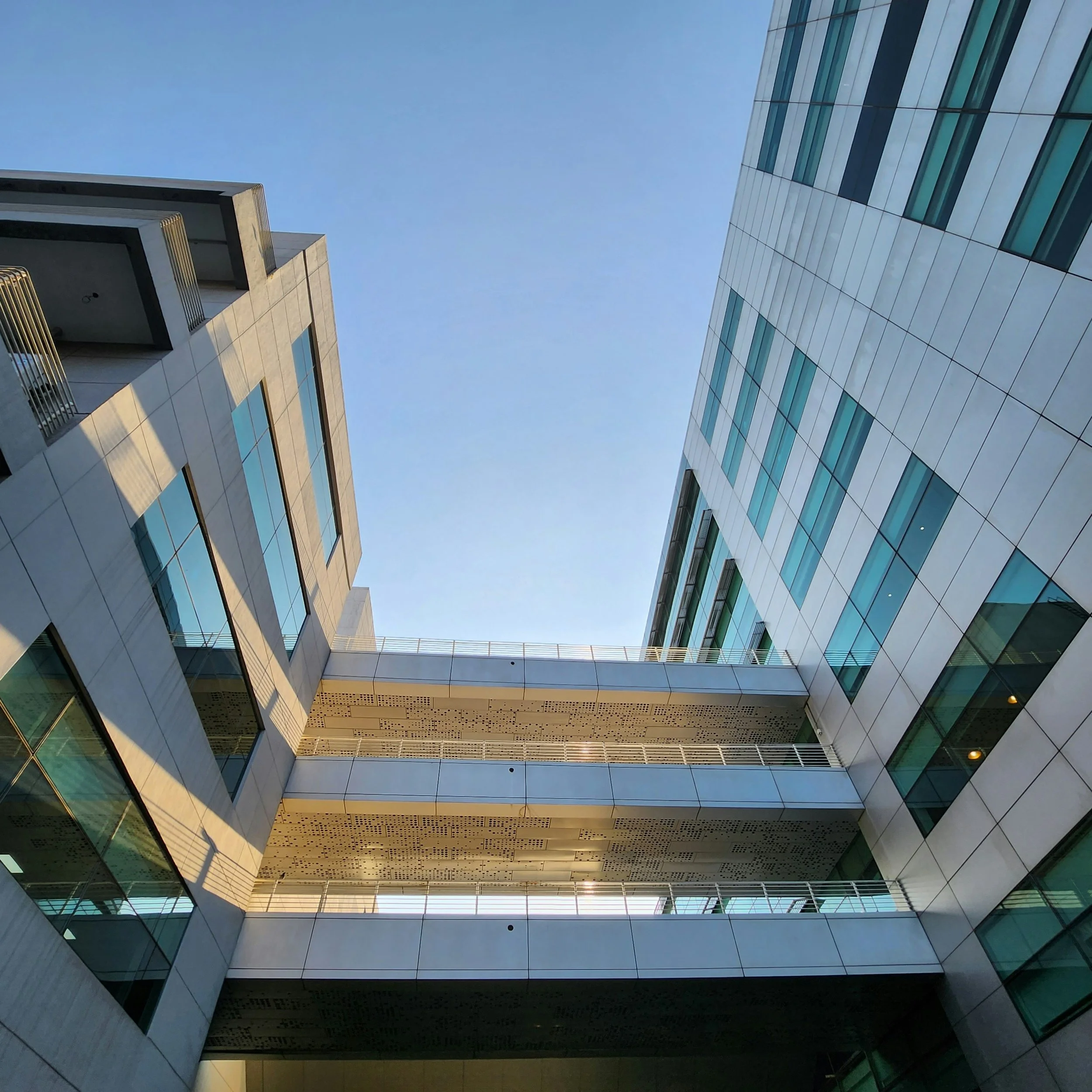A view looking up at the sky among office buildings
