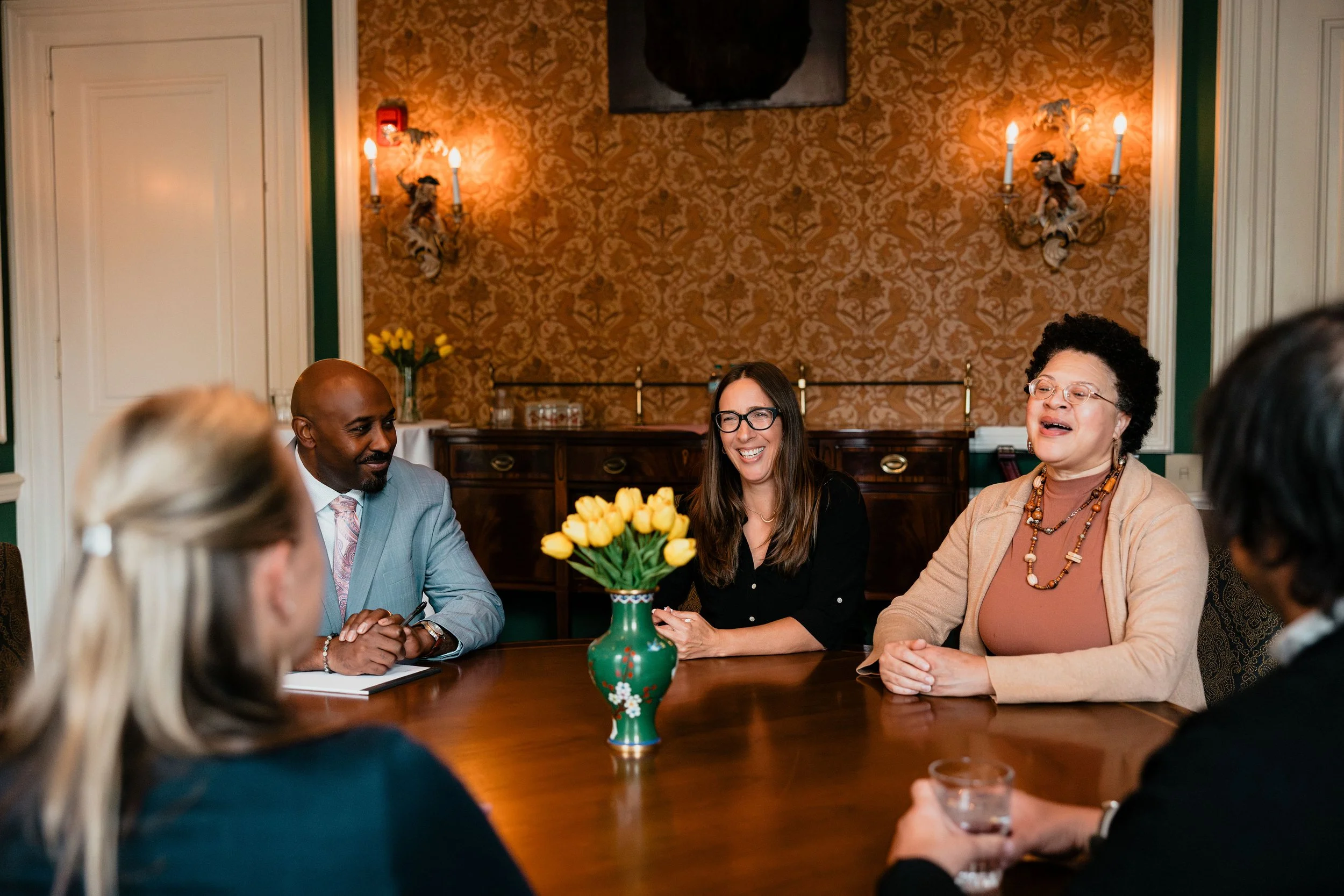 Consulting Collaborative partners sitting around a table talking to clients