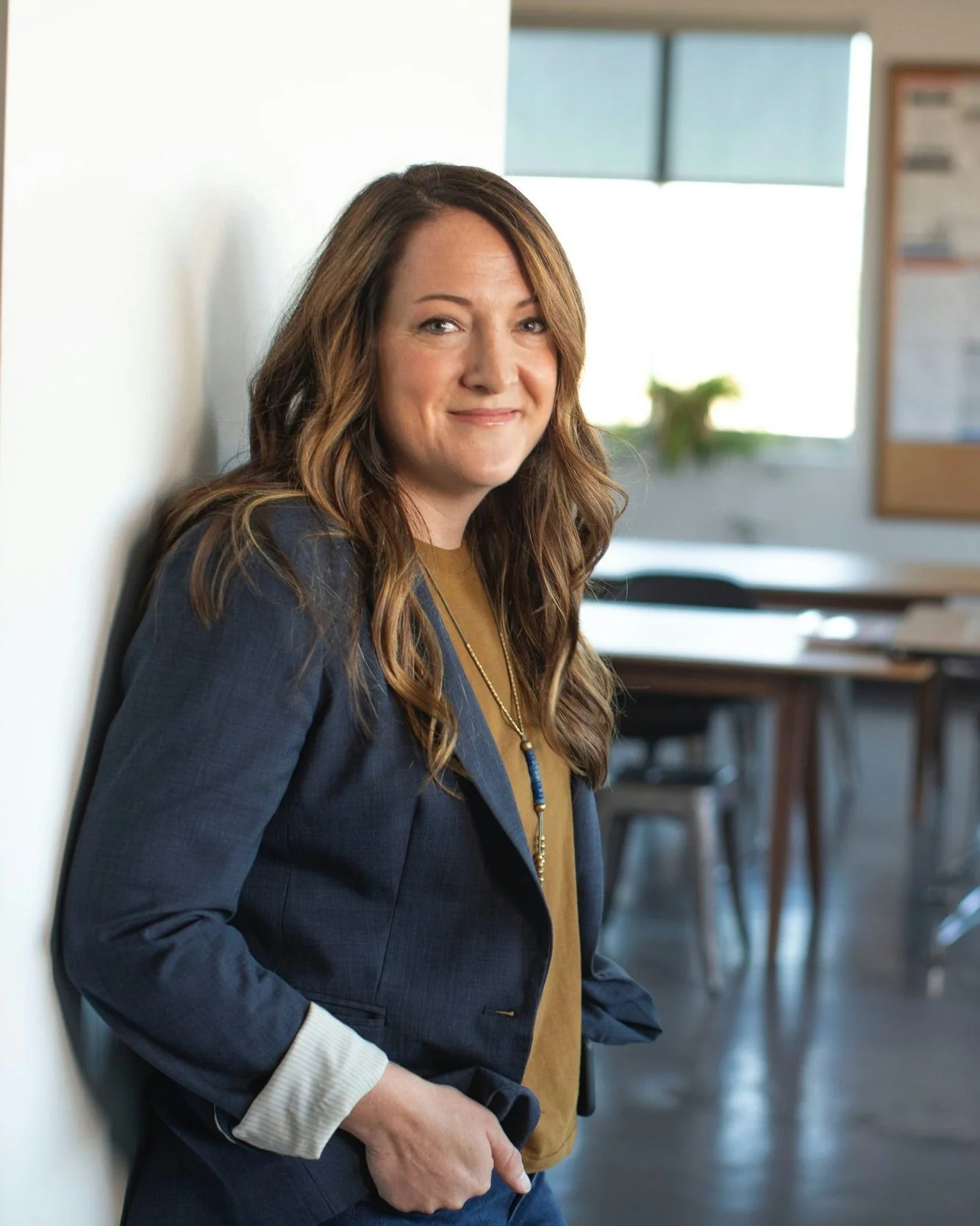 Woman in casual business attire confidently smiling