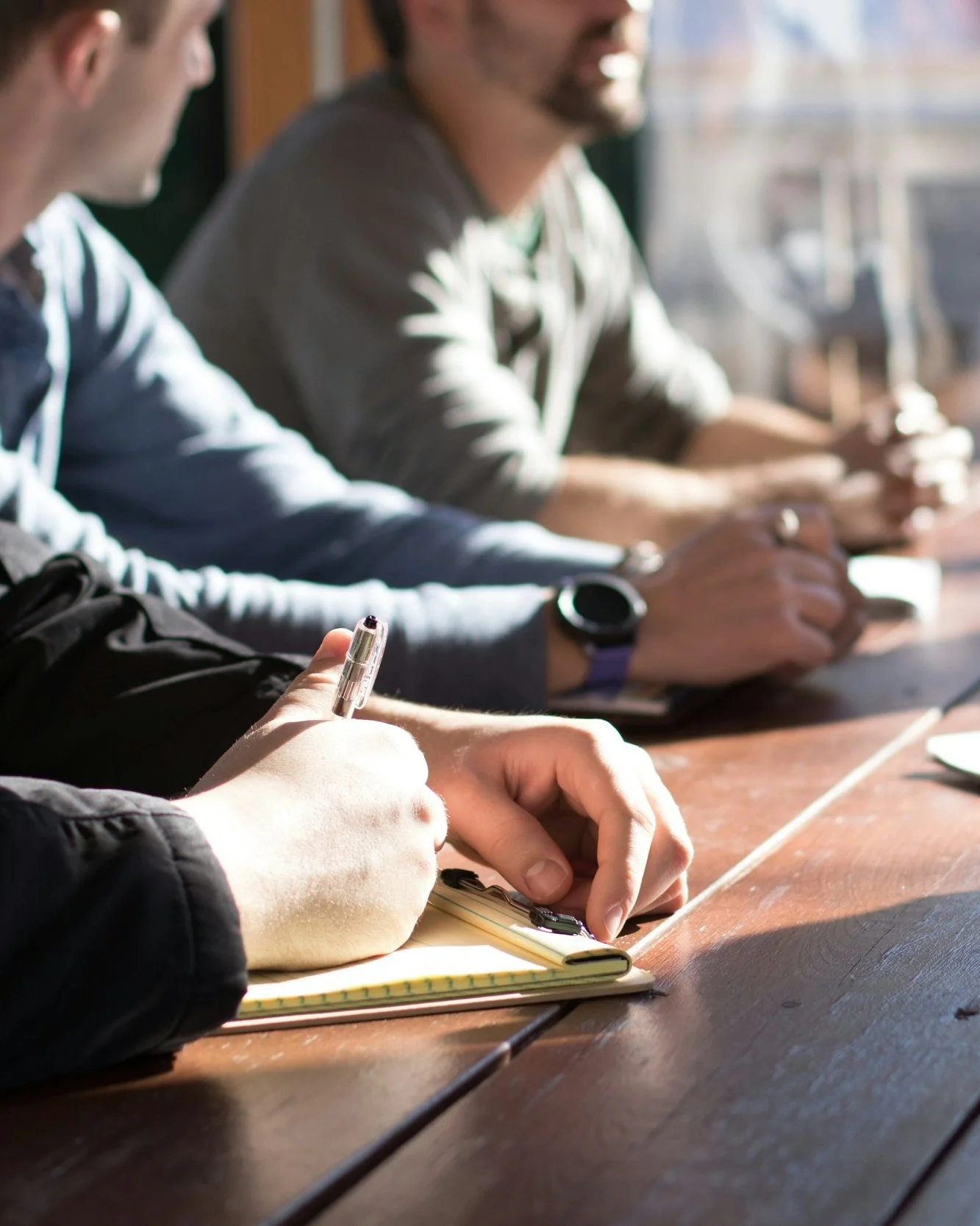 People sitting at a table taking notes