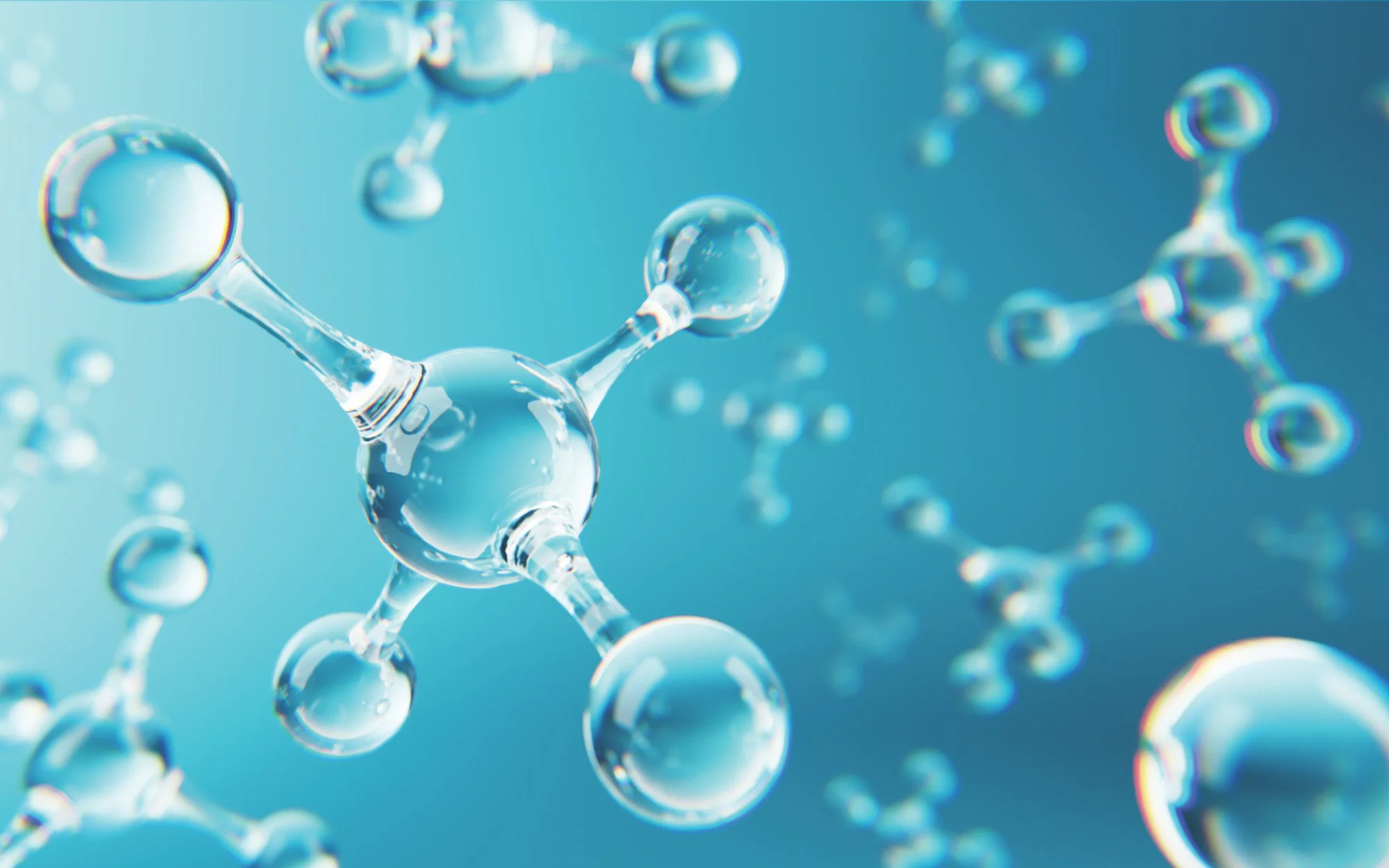 A digital representation of water molecules, showing oxygen atoms as larger spheres connected to two hydrogen atoms, floating in a blue background.