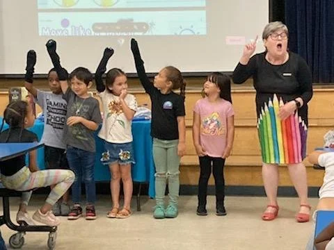 Elementary school students participating in poetry assembly