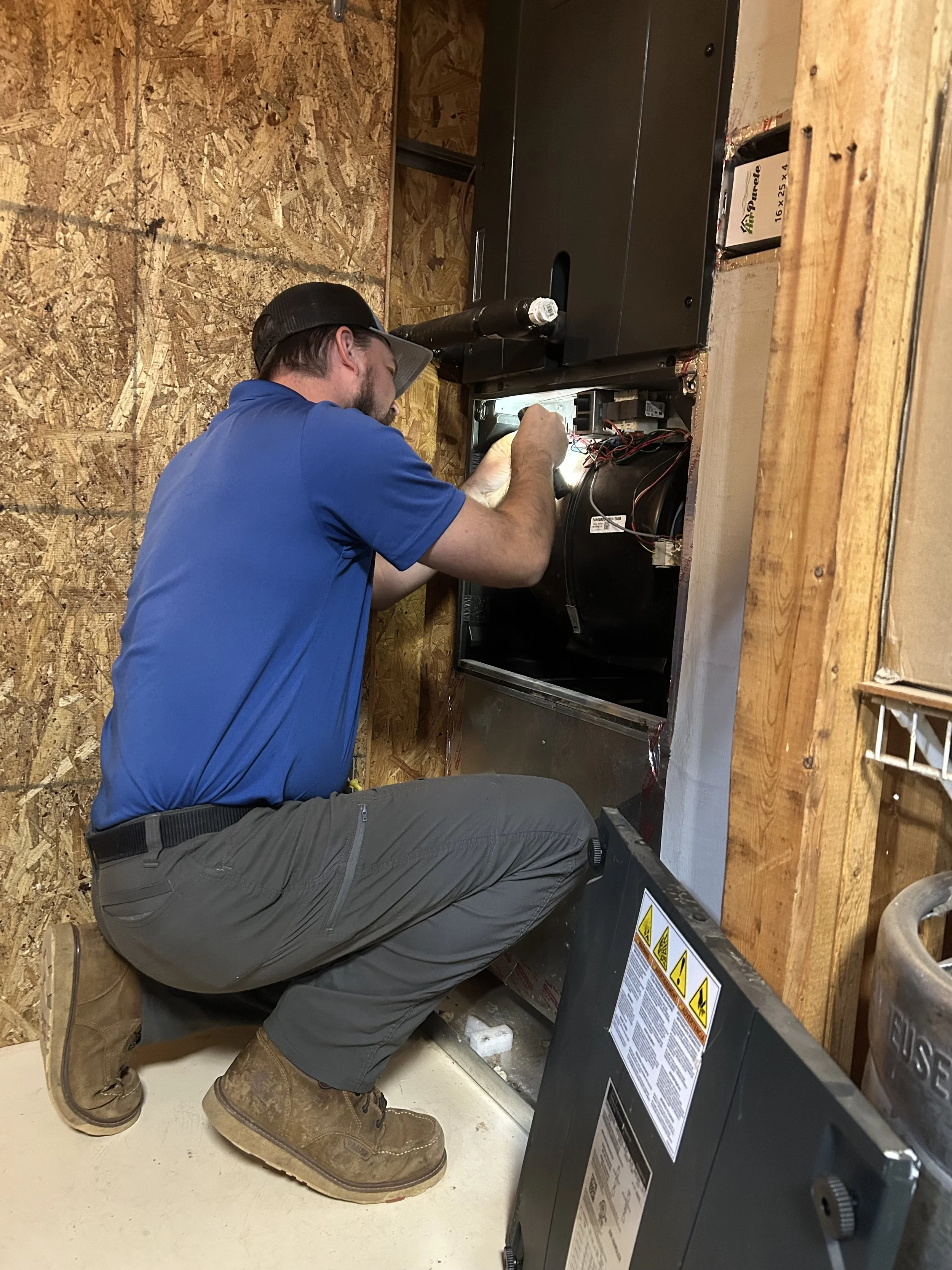 HVAC Tech Performing Maintenance Check-Up