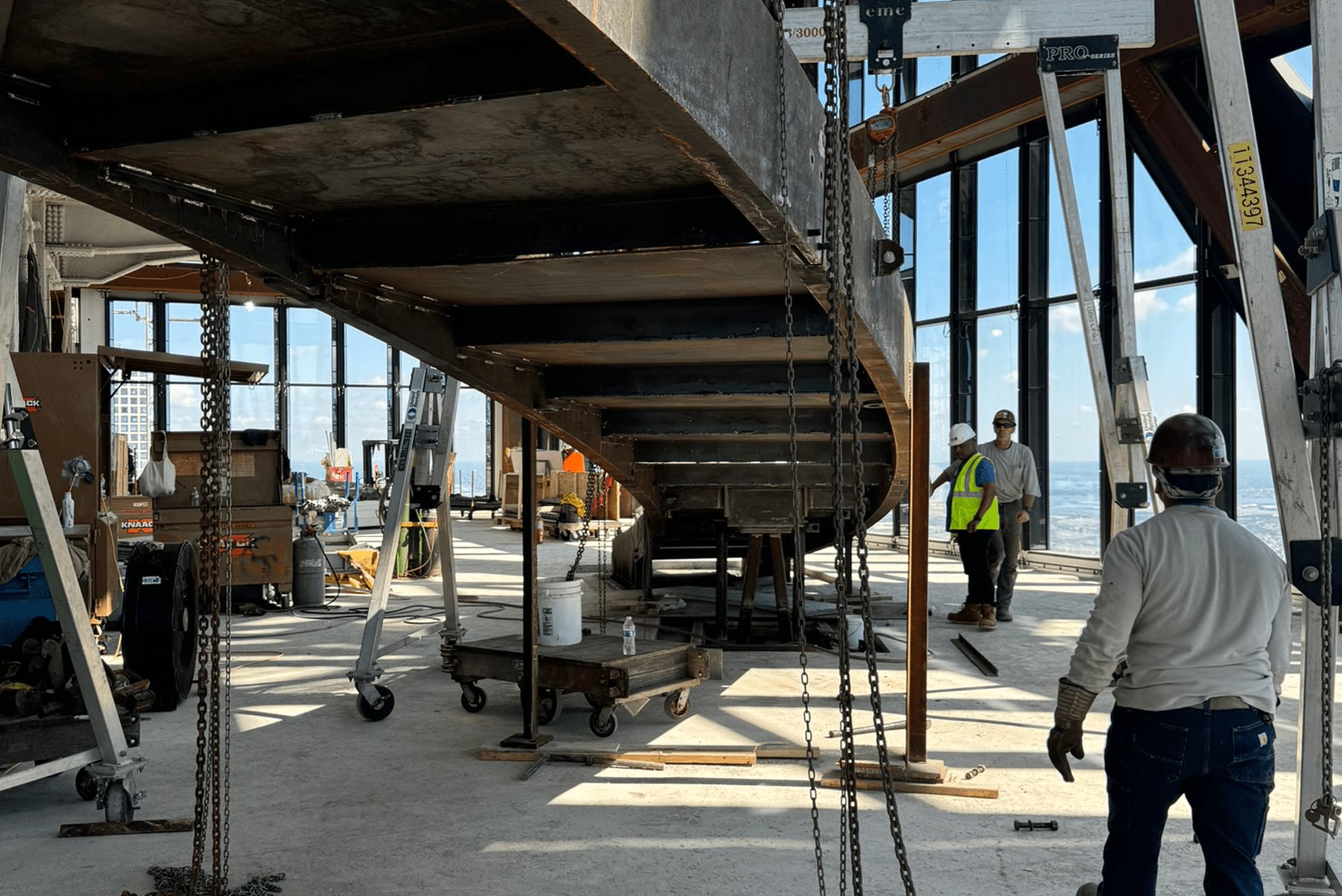 The staircase being installed in JP Morgan Chase headquarters. Workers are performing quality assurance.