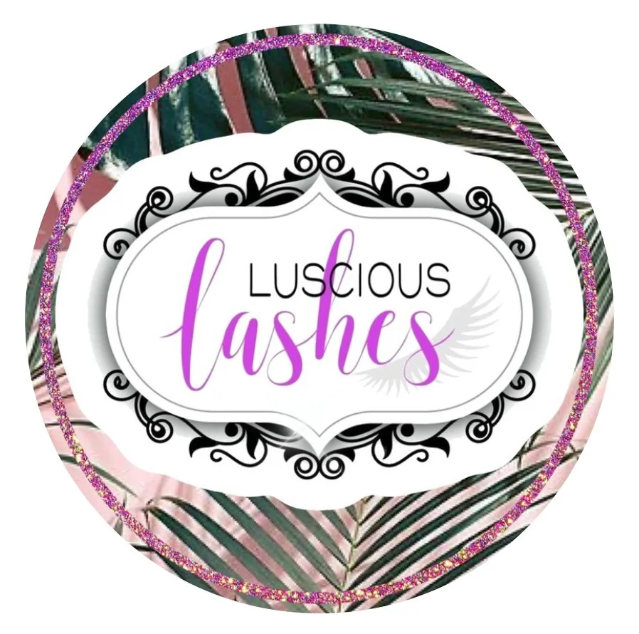 A circular logo with pink and green tropical leaf patterns. The center text says 'Luscious Lashes' with 'Luscious' in black and 'Lashes' in purple, surrounded by a decorative black and white border.