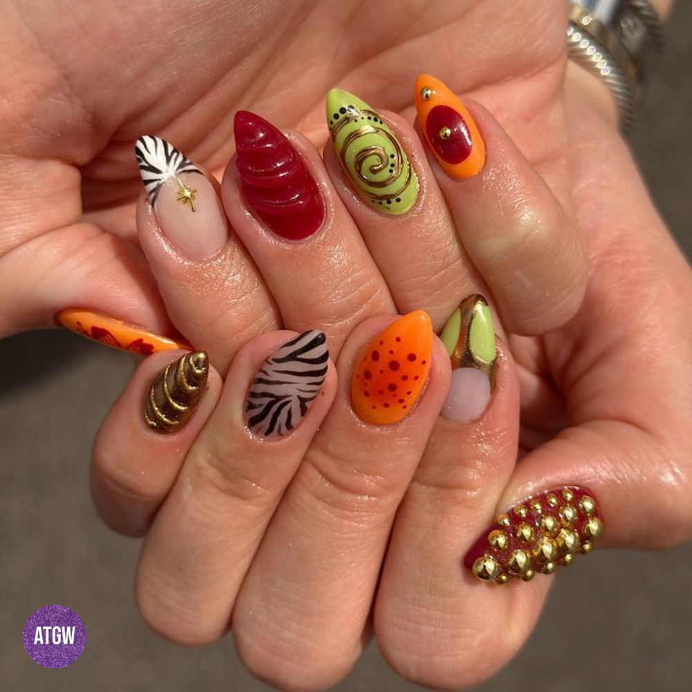 Fall nail design featuring 3D studs, zebra stripes, spiral swirls, and multi-textured art.