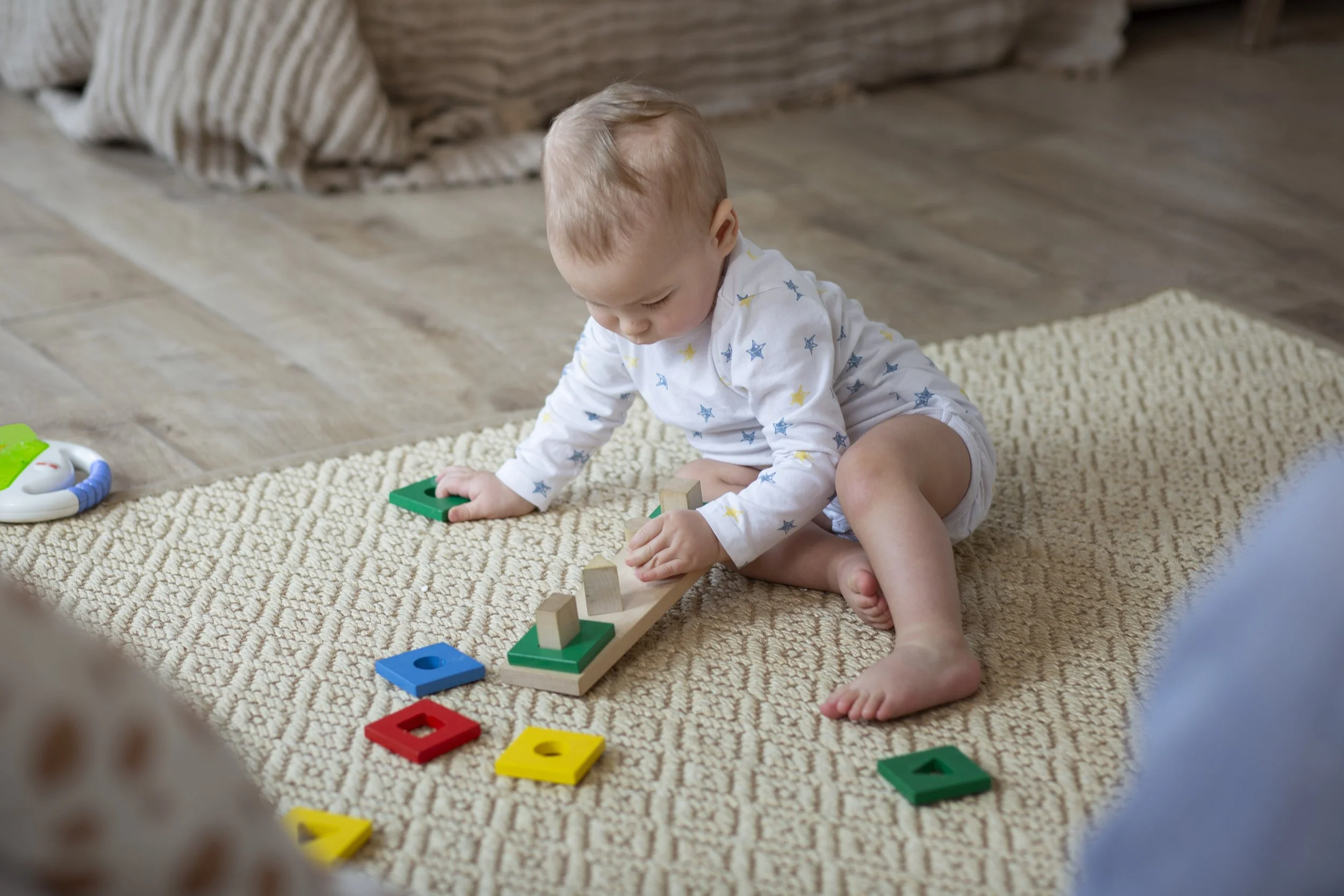 full-shot-cute-baby-playing-floor.jpg