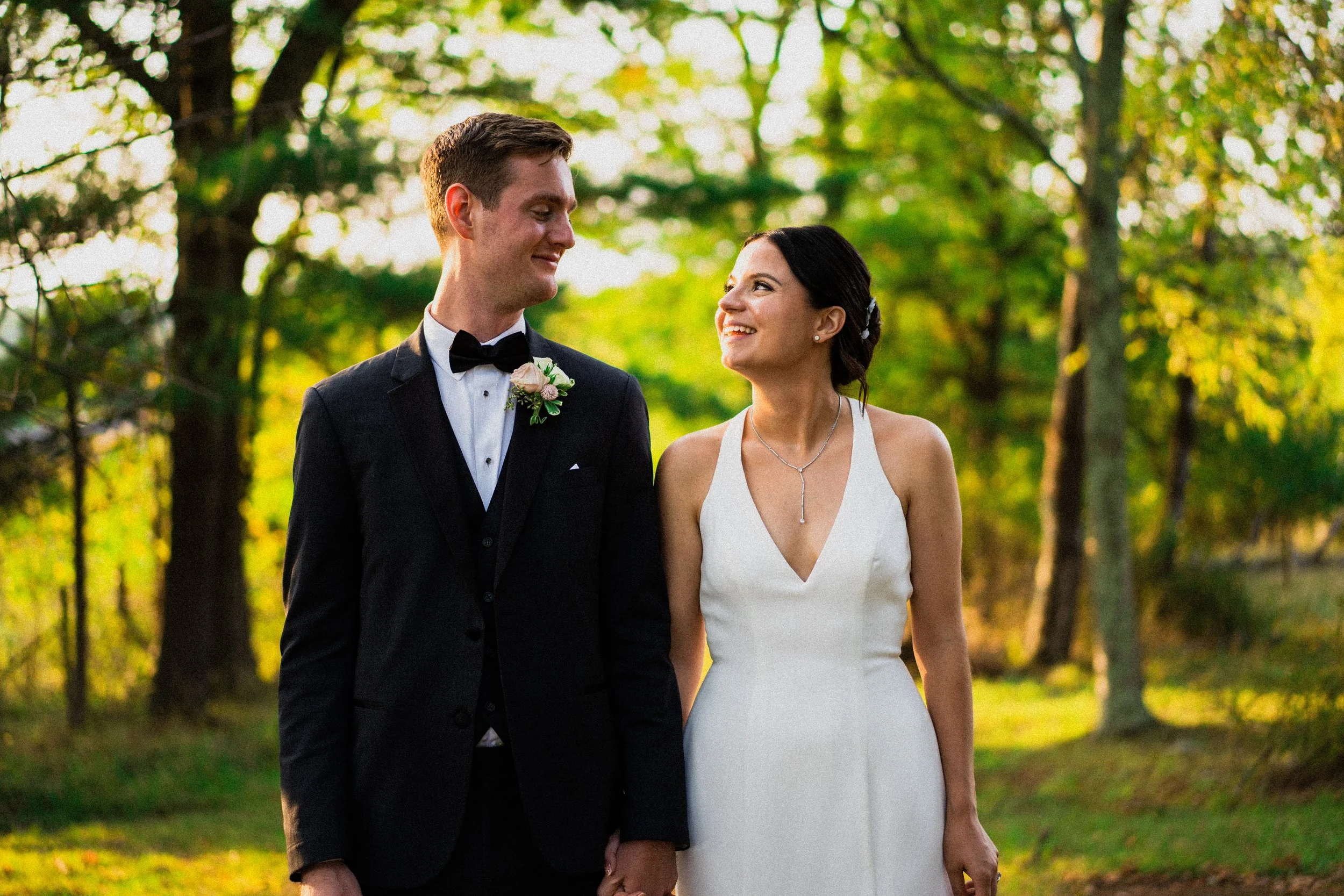 A wedding photographer capturing a couple in a romantic pose against the backdrop of New York City's skyline.
