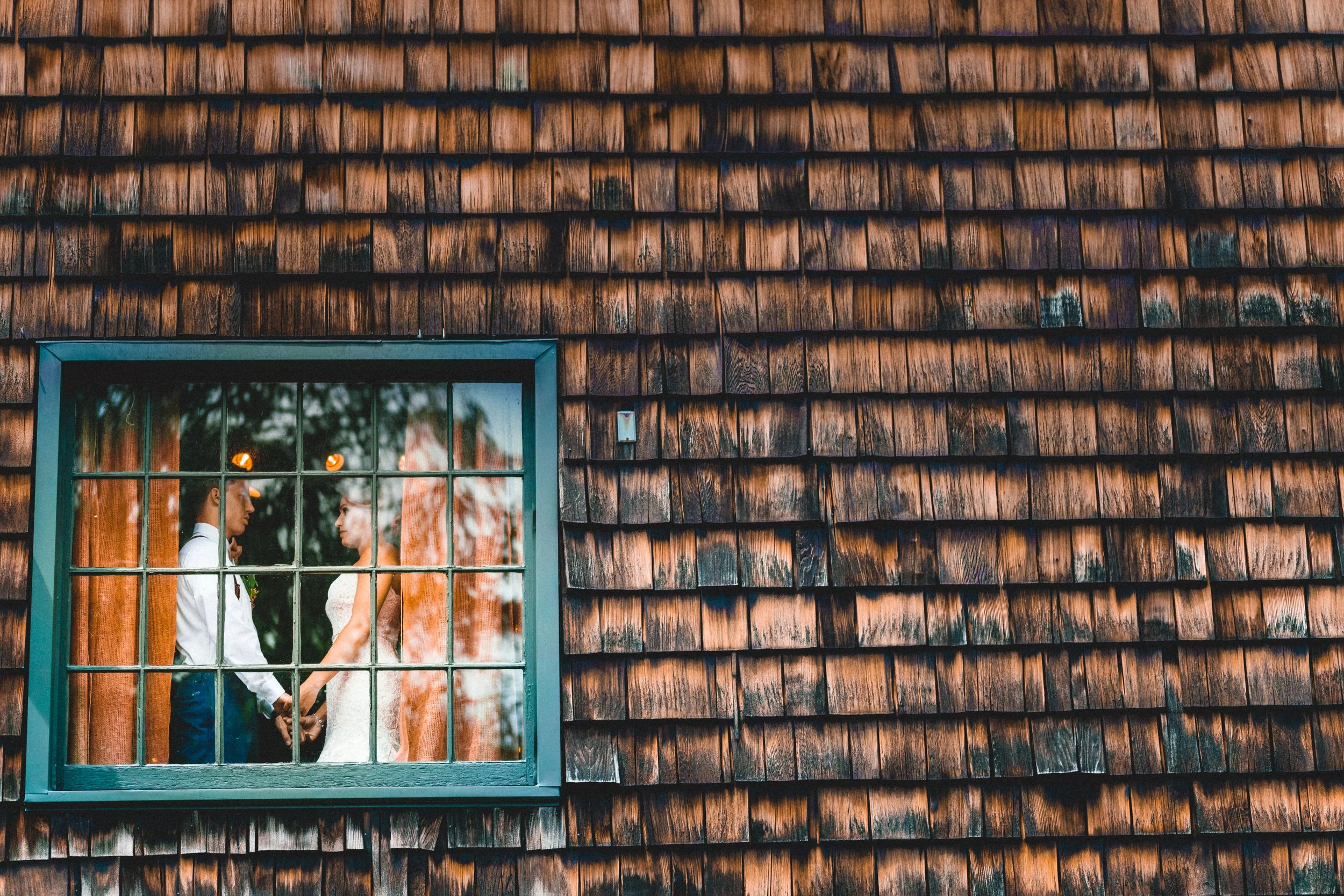 A wedding photographer capturing a couple in a romantic moment in New York City, with iconic skyline in the background.