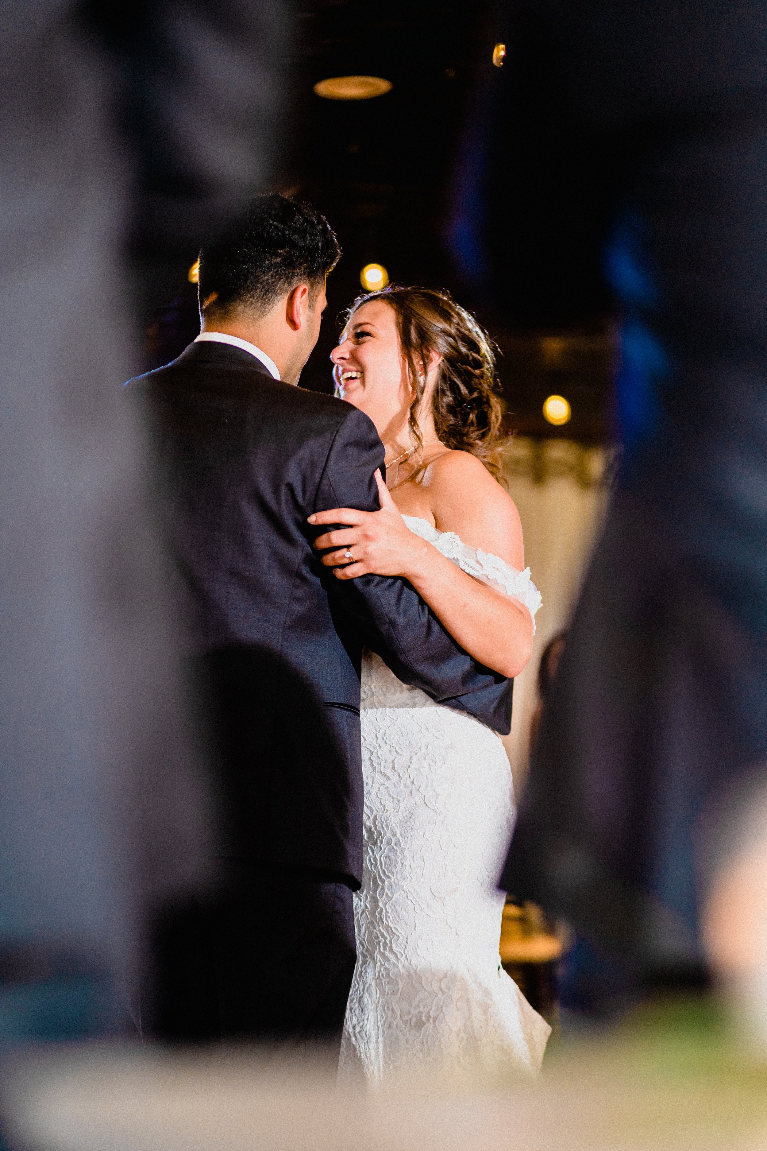 A picturesque wedding ceremony at a rustic barn in a New Hampshire farmhouse, surrounded by lush greenery and floral decor.