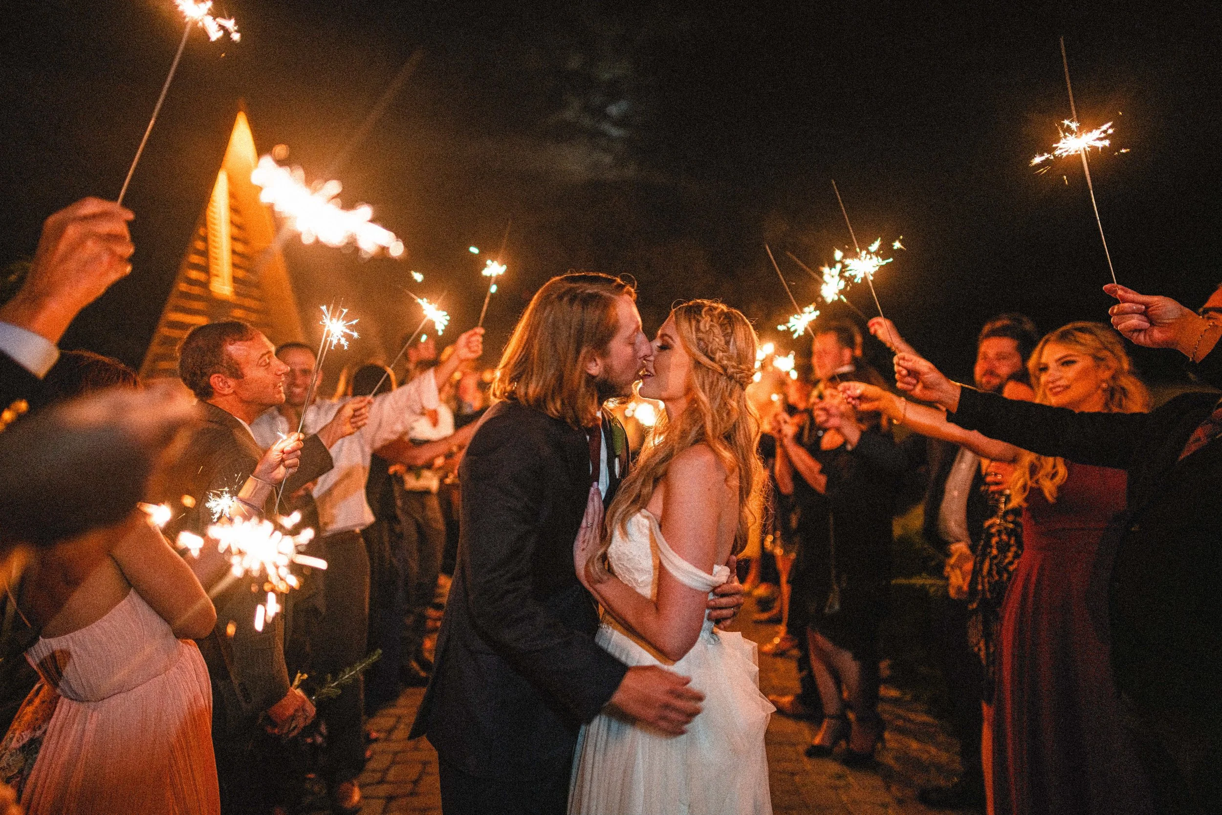 A collection of wedding sparklers glowing brightly against a dark background, creating a festive atmosphere for celebrations.