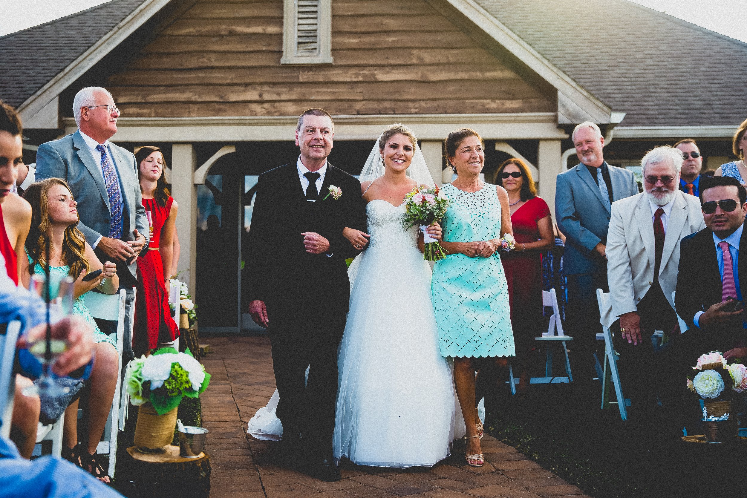 A bride and groom joyfully walk down the aisle together during their wedding ceremony.