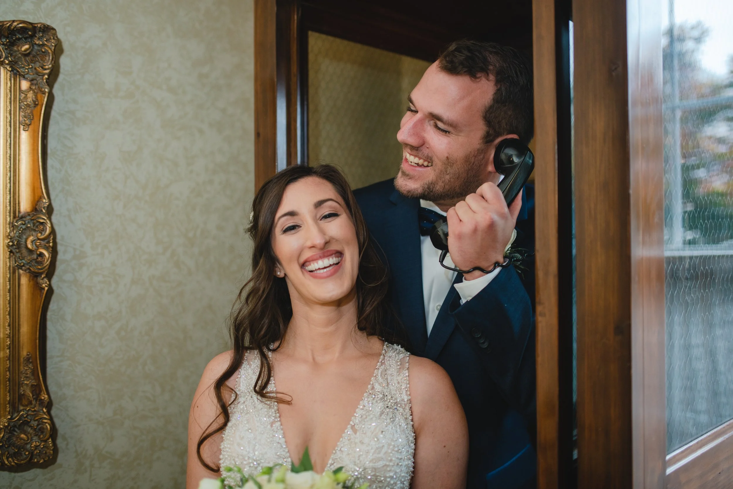 A wedding photographer capturing a couple in a romantic moment in New York City, with iconic skyline in the background.