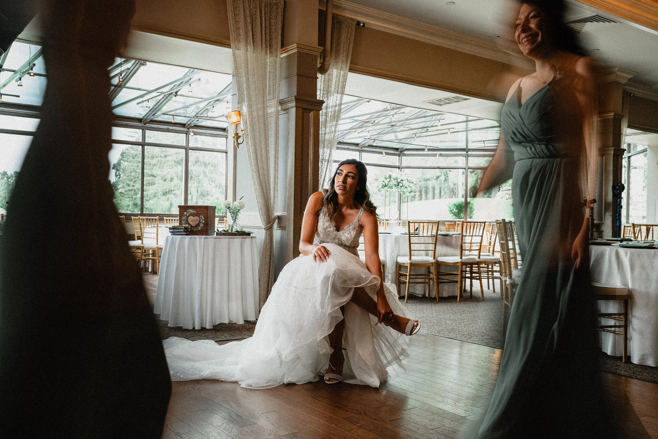 A wedding photographer capturing a couple in a romantic New York City setting, with iconic skyline in the background.