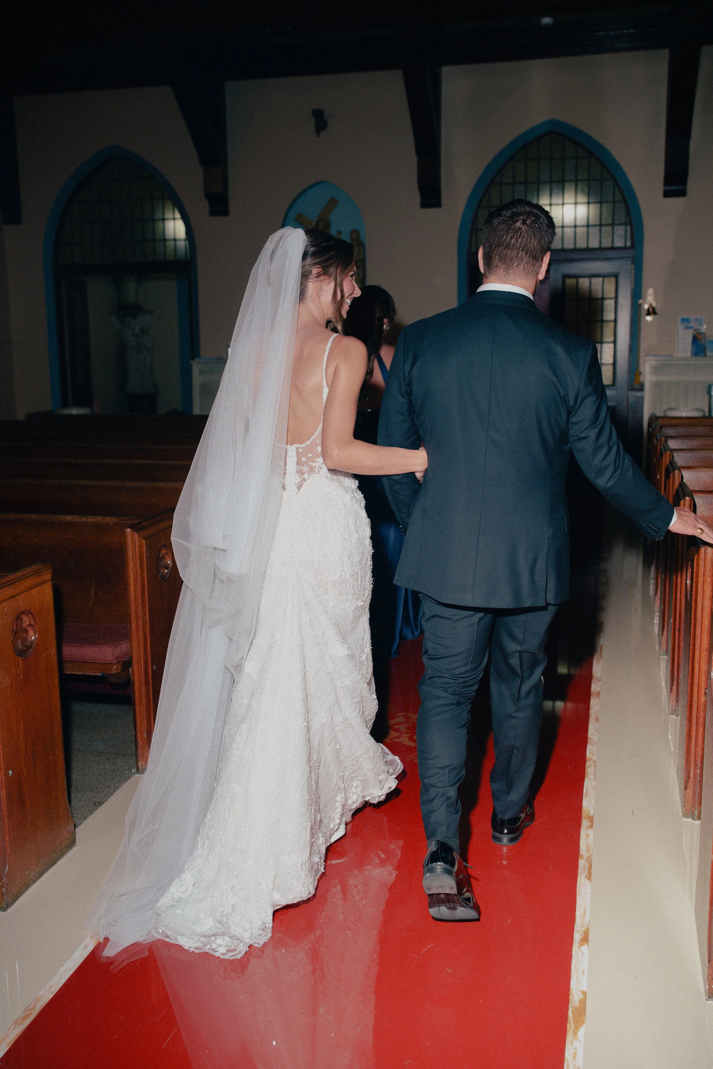 NJ Wedding Photography  of a bride and groom walking down the isla as they exit their nj wedding ceremony