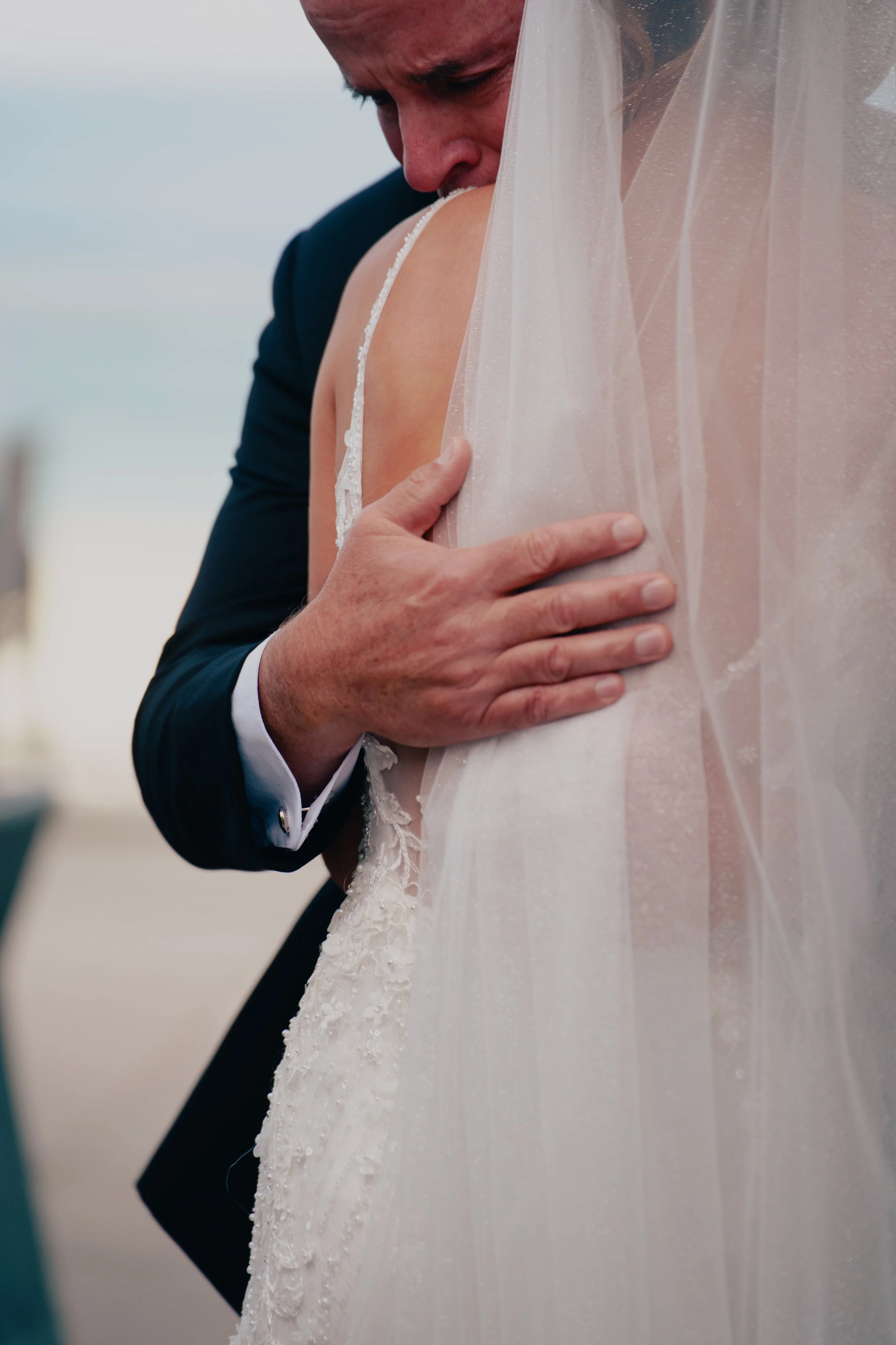 Close-up of a brides father hugging his daughter on her wedding day at Wave resort - NJ Wedding photographers- Timeline Visuals