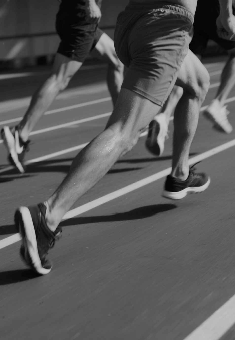 Athletes running on a track during a race.