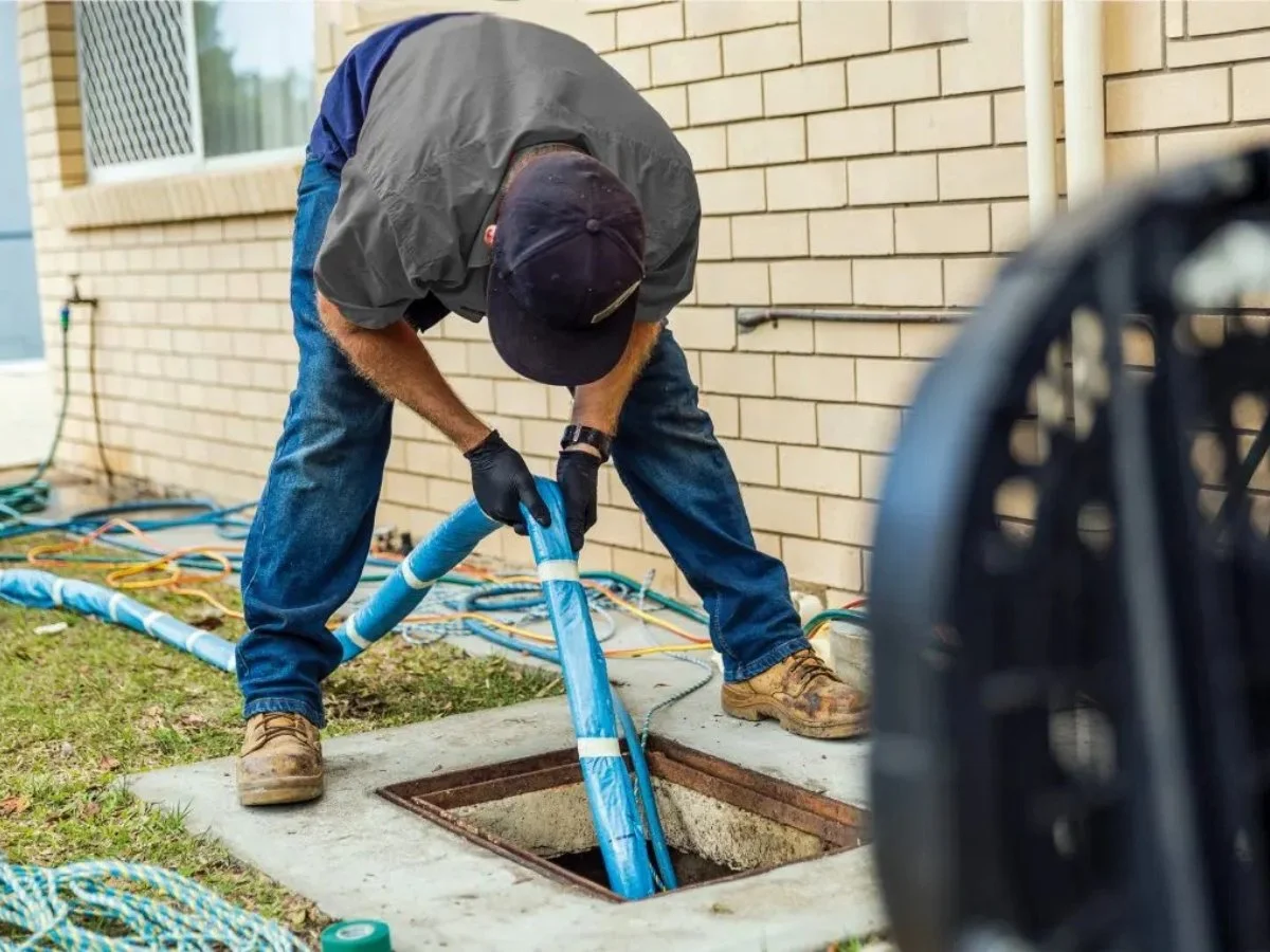 plumber working on a trenchless sewer pipe repair