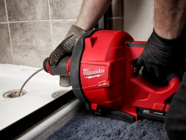 plumber using drain snake for main drain cleaning in broomfield CO