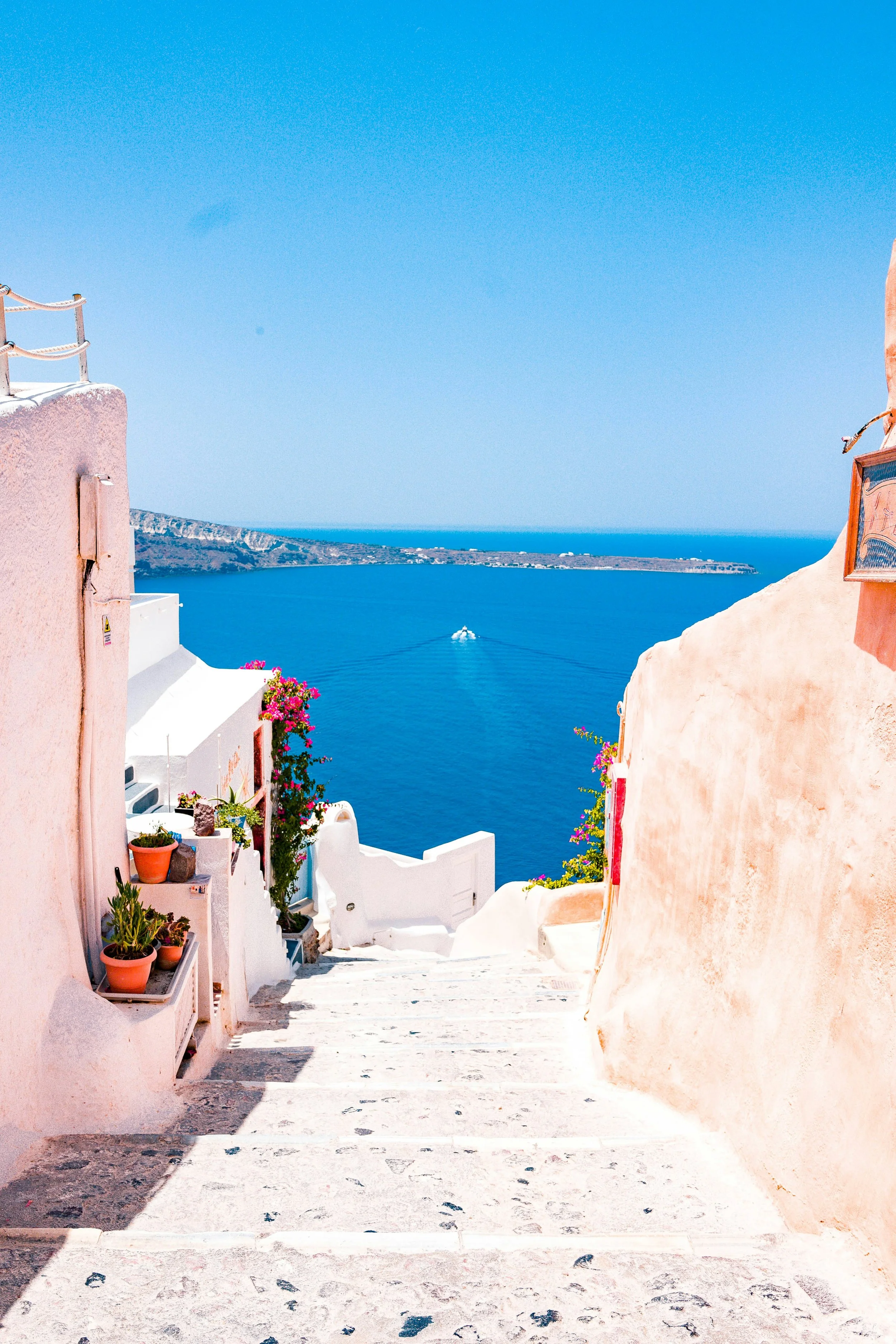 Whitewashed steps overlooking the Aegean Sea in Greece, a dreamy honeymoon destination for couples
