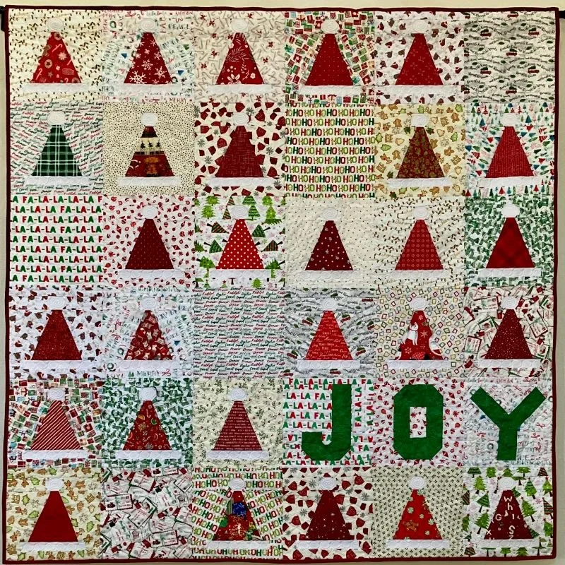 Kringle's Kaps 60" x 60" 5/26 Santa's Hat Shop Quilt by Melisa Mortenson