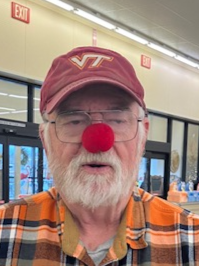 Close up of a man with a hat and red nose