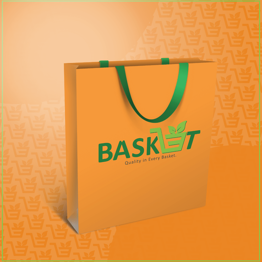 Orange shopping bag with green handles and the green BASKET logo and slogan “Quality in Every Basket.”