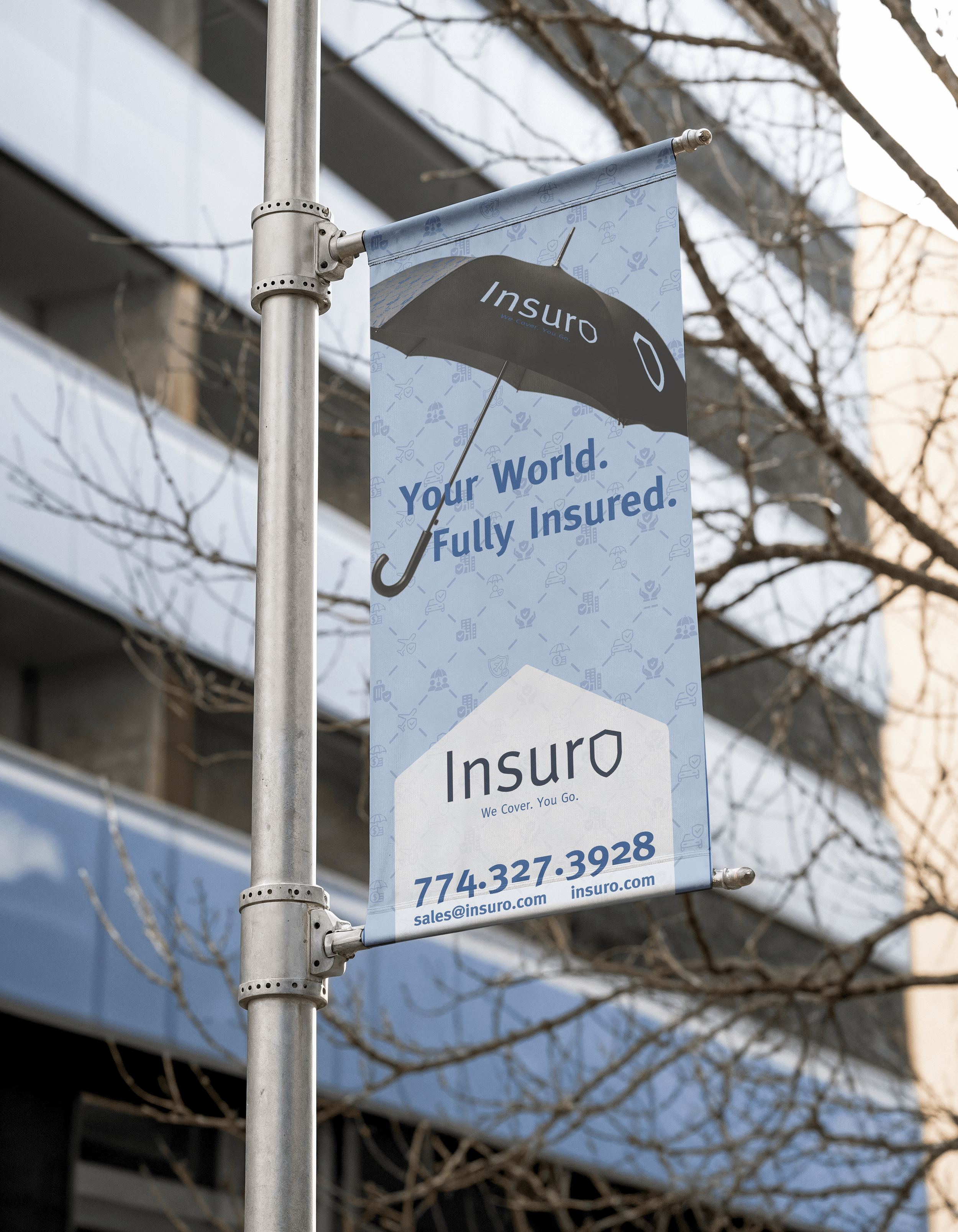 A vertical banner for Insuro insurance company hanging from a metal pole, featuring a black umbrella with the company's name and logo, and the tagline "Your World. Fully Insured." made by vivfty!