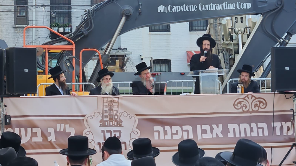 The dais at the Hanachas Even Hapinah event with the campaign banner.