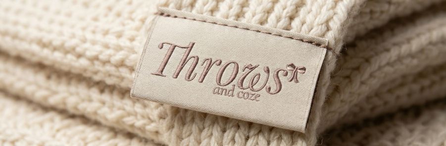 A woven Throws & Coze label stitched onto a chunky cream knit.
