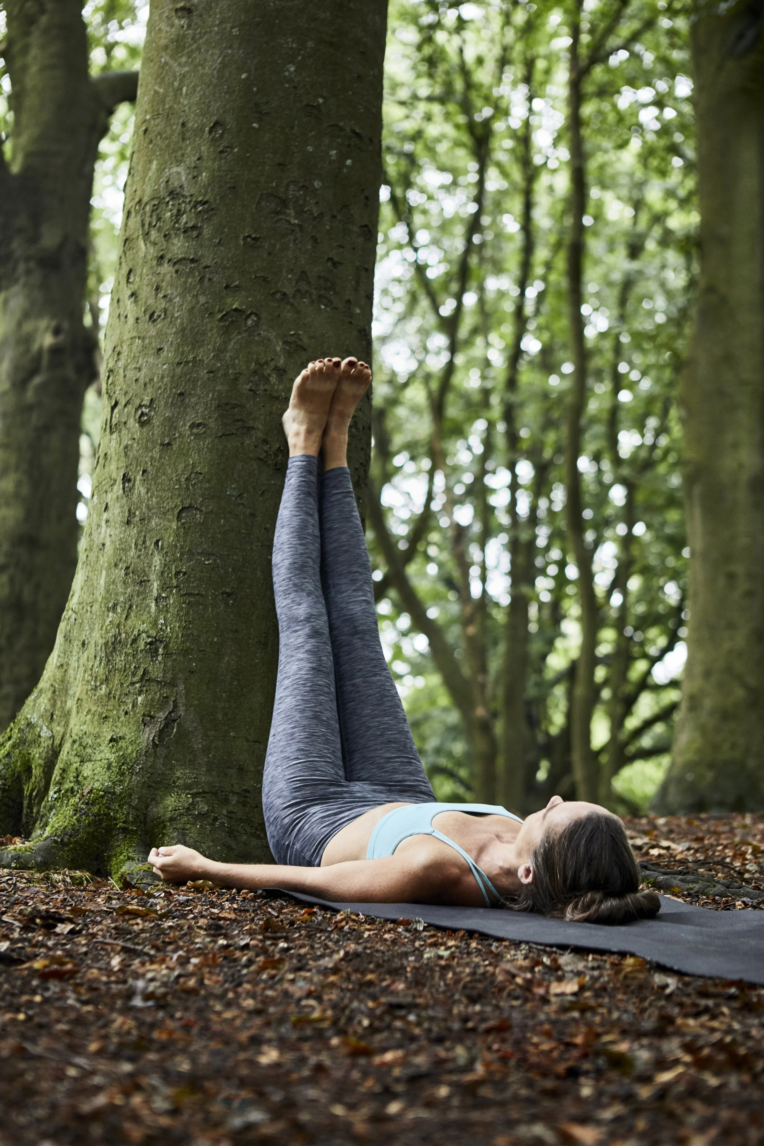Restorative Yoga in nature with tree