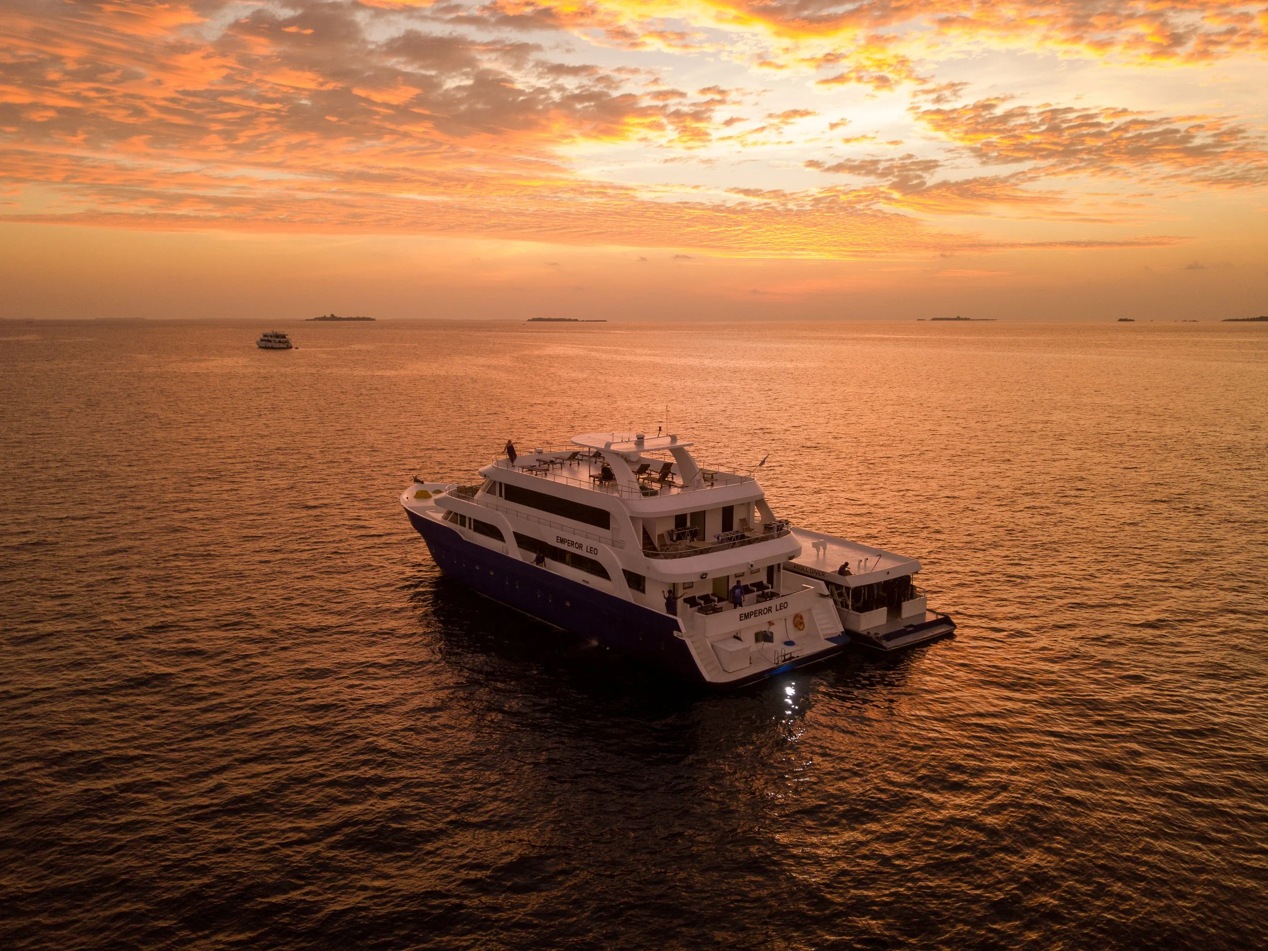 A large yacht at anchor at golden hour