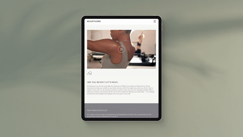 A tablet displaying a fitness website with a woman stretching in the header image.