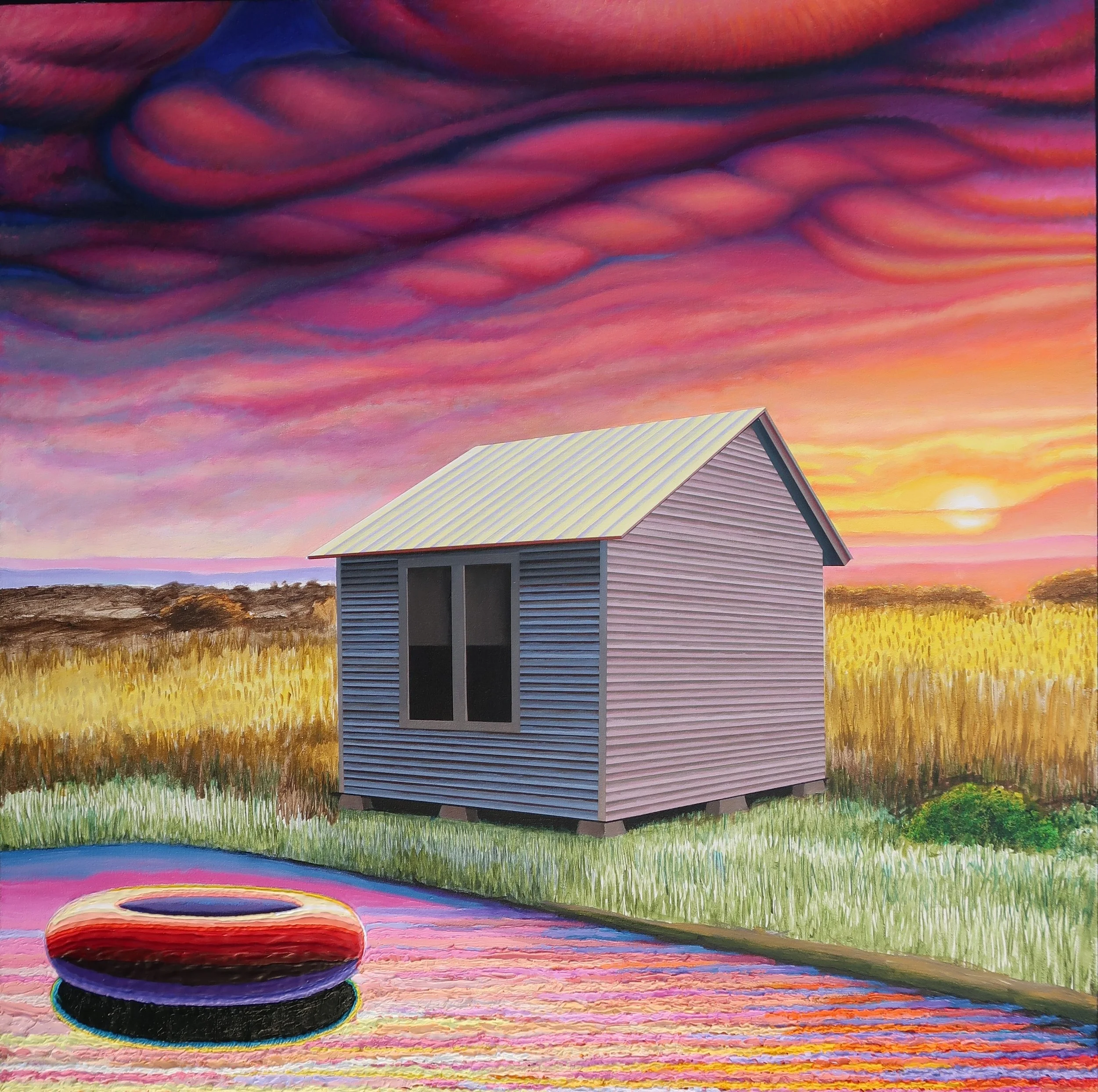 A small house with a gabled roof and siding, sitting on stilts in a field during sunset with a colorful sky and a floating tire in the foreground.