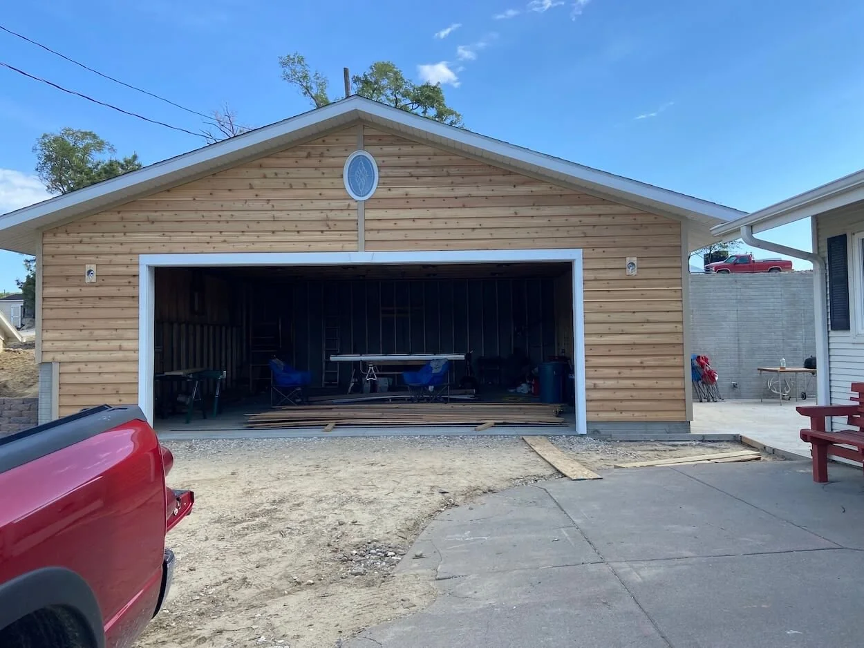 new double garage with wood siding