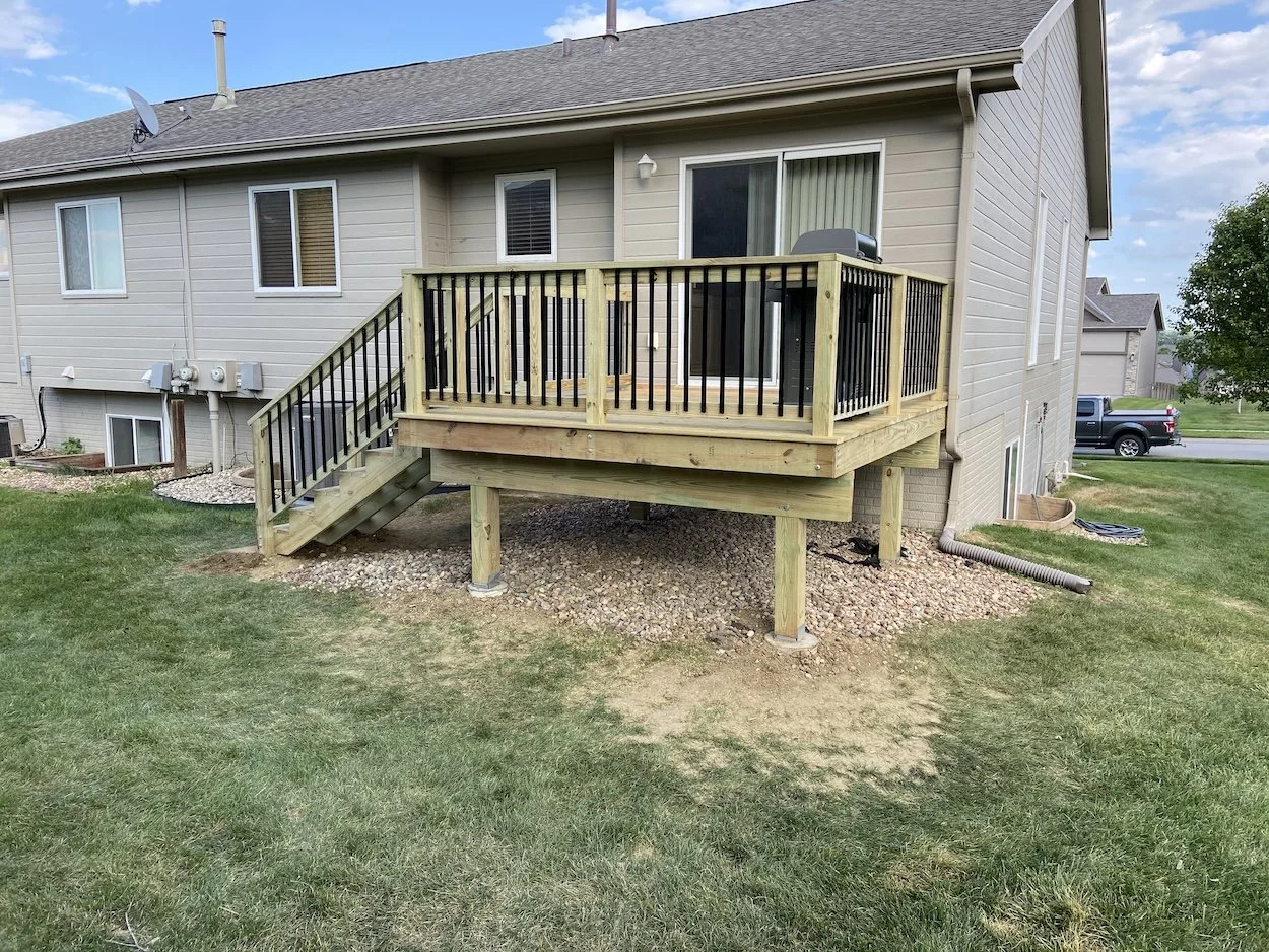 remodeled deck with wood and metal railing
