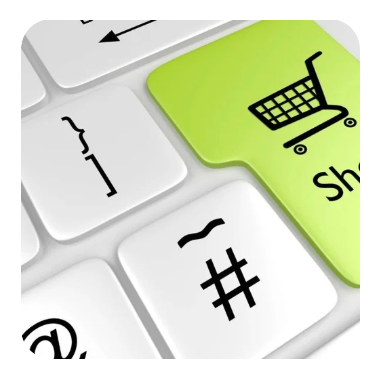 Close-up of a computer keyboard with a yellow-green key featuring a shopping cart icon and the word "Shop."