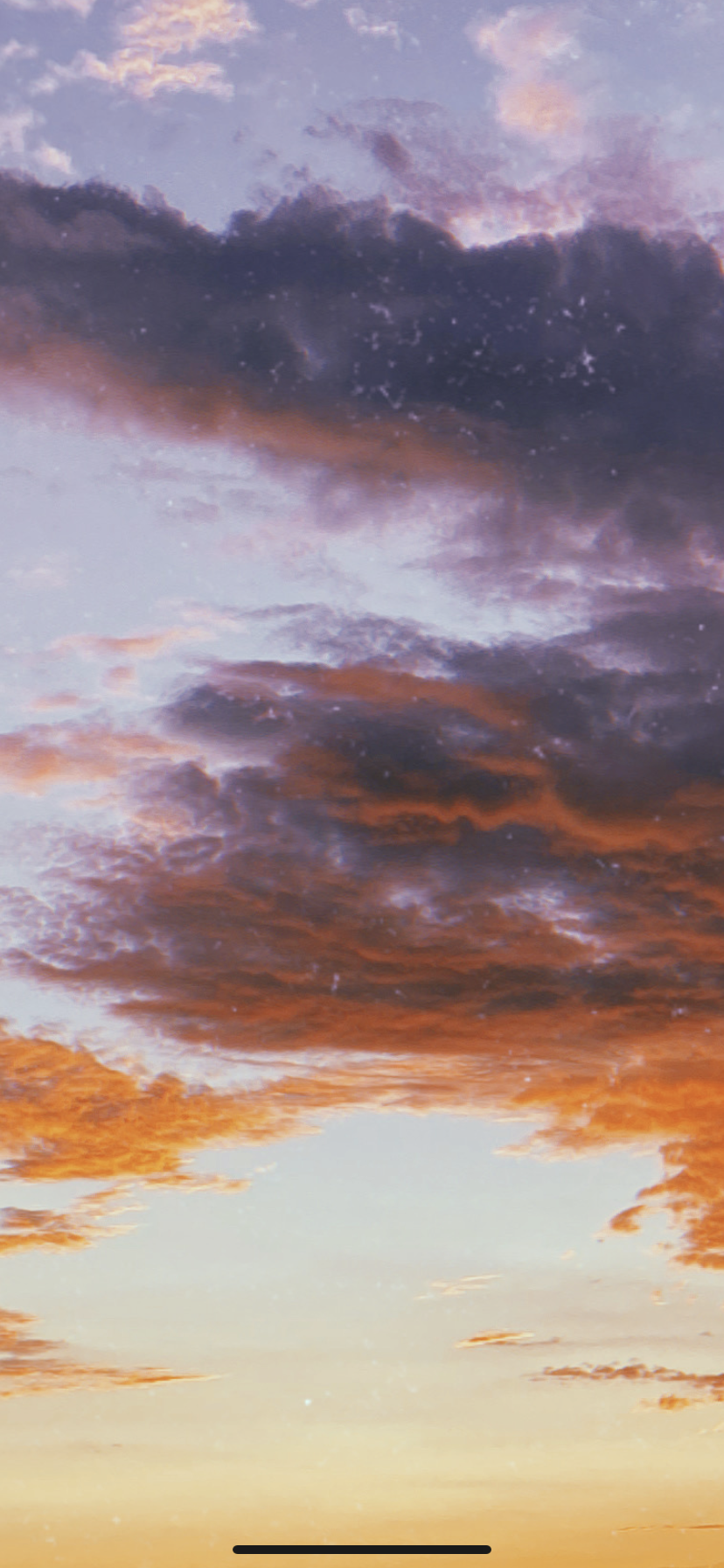 Colorful sky during sunset with clouds showing shades of purple, orange, and pink.