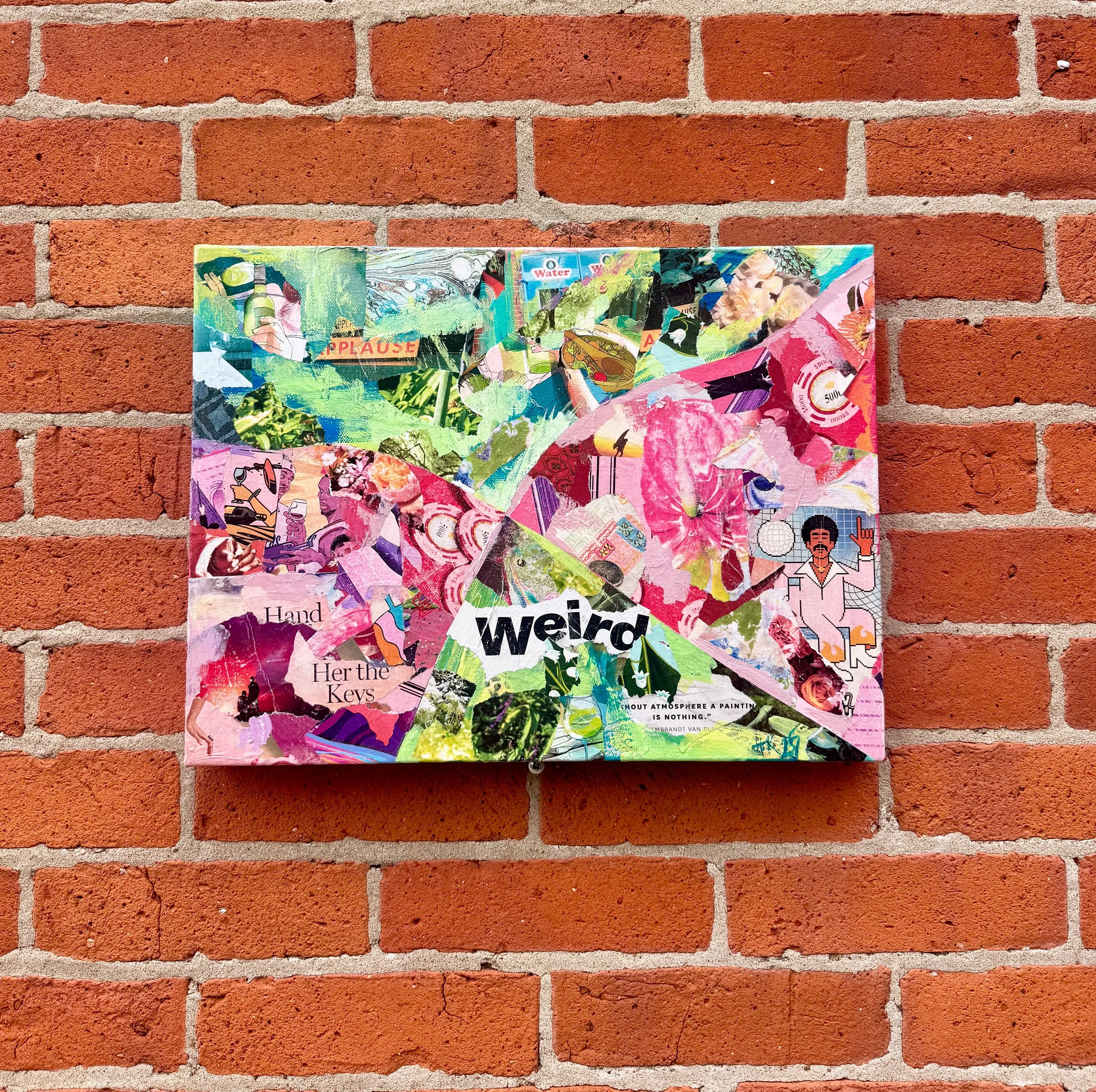 Colorful collage artwork mounted on a brick wall, with the word 'weird' in the center.