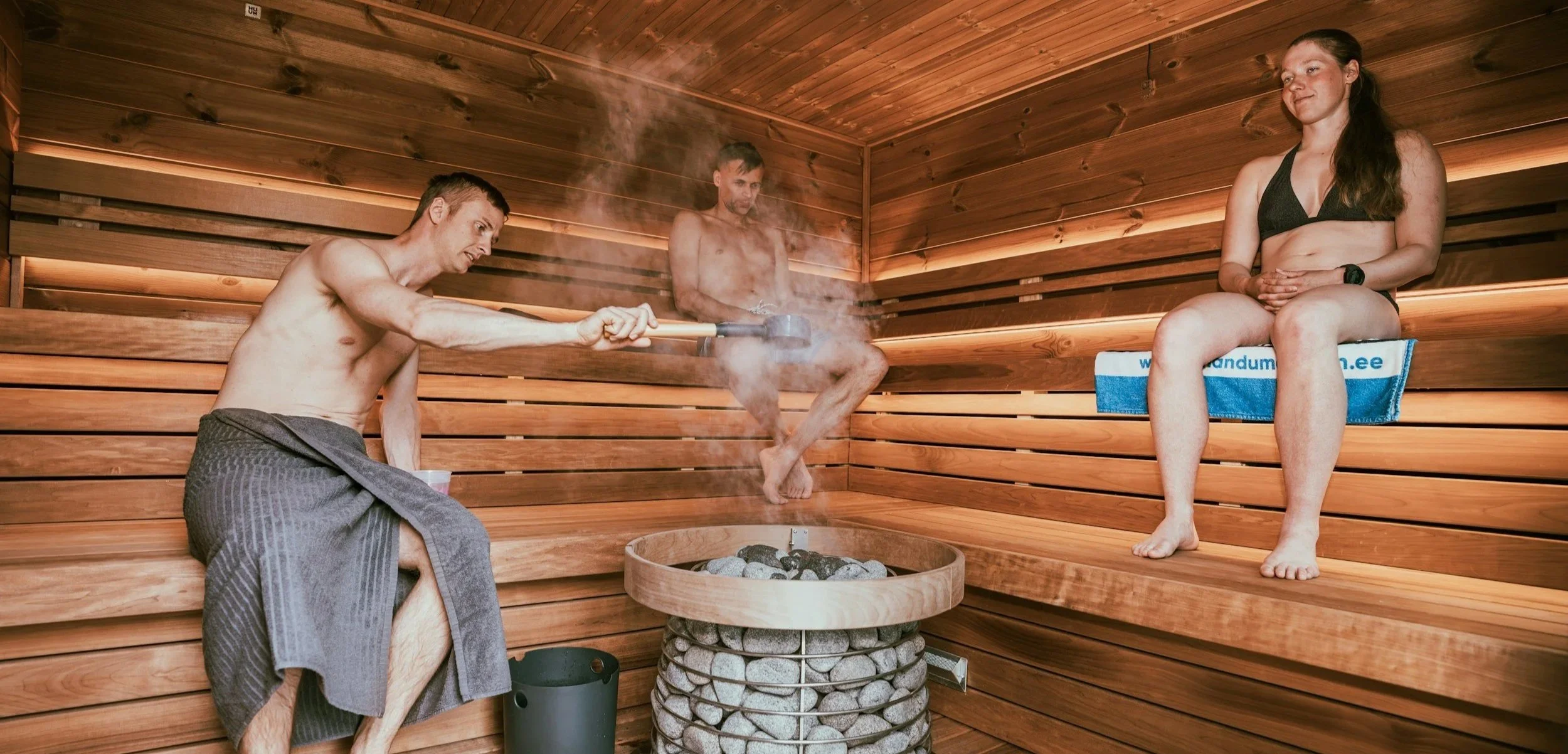 Illustration of people sitting in a sauna, highlighting the benefits of heat exposure for muscle and brain health.