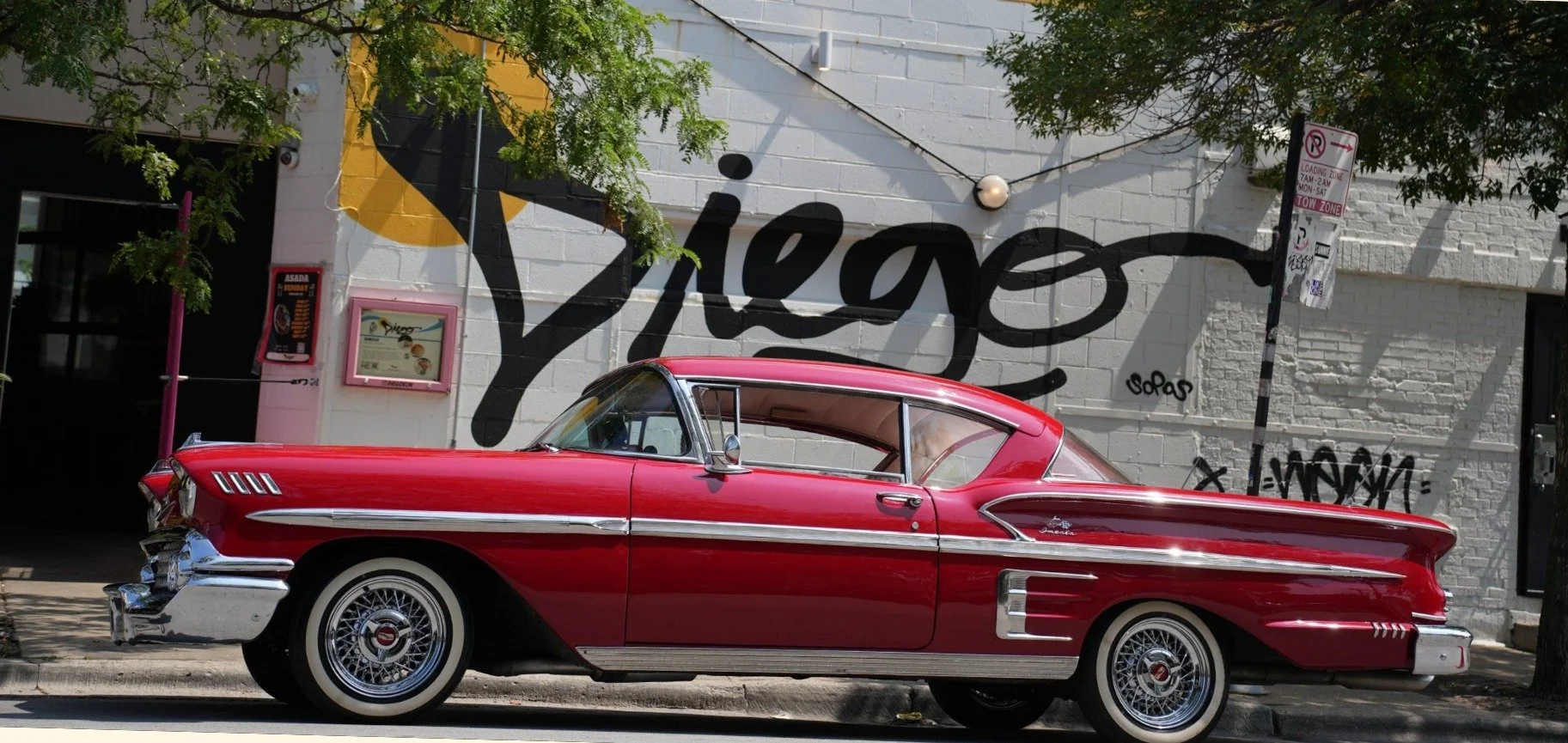 Classic red car in front of the Diego mural at 459 N Ogden, West Town