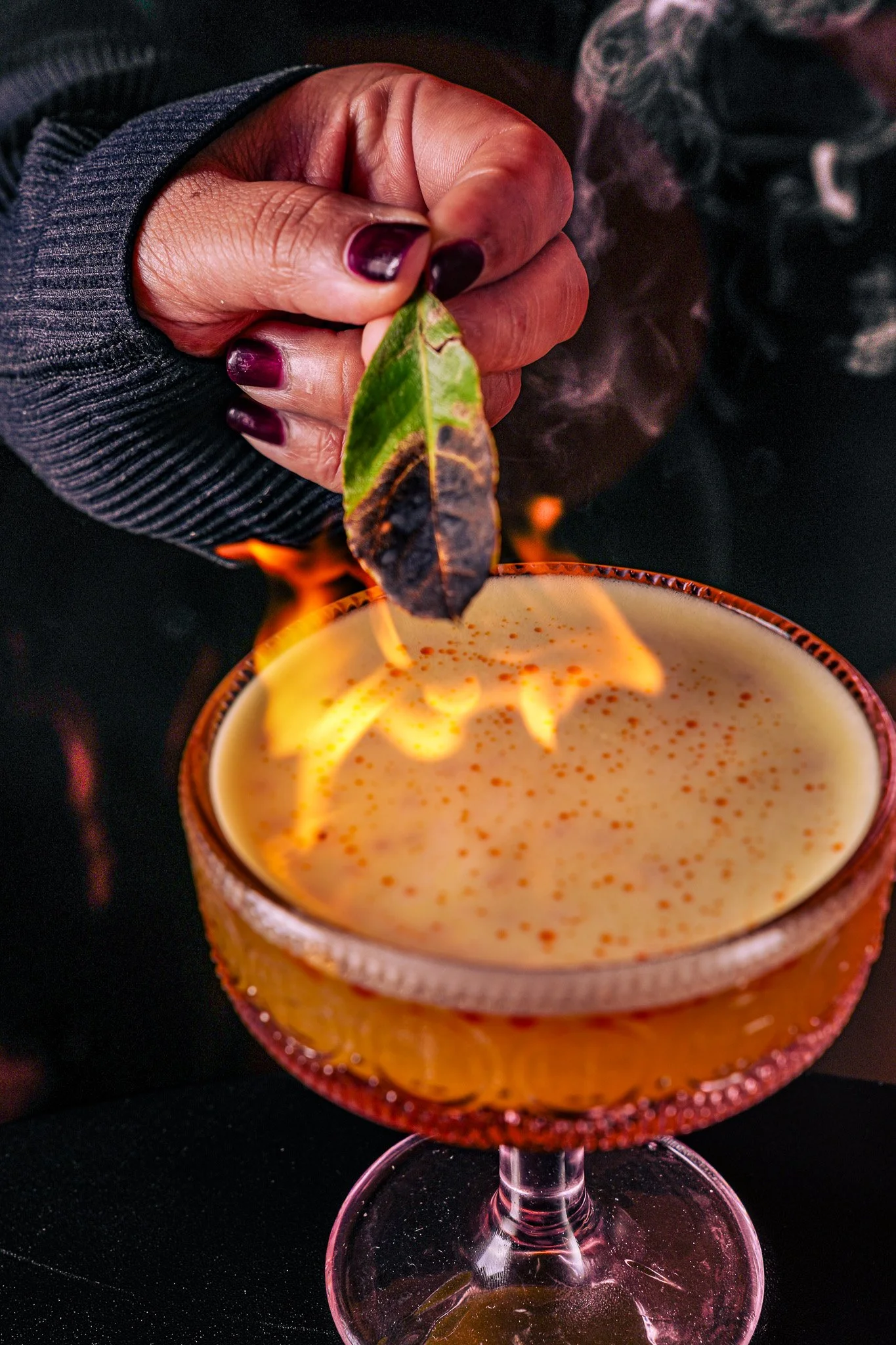 A cocktail finished with a flame at Trino