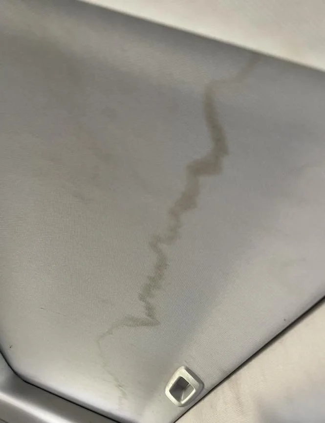 Water stain or leak mark on the interior roof of a vehicle or building ceiling.